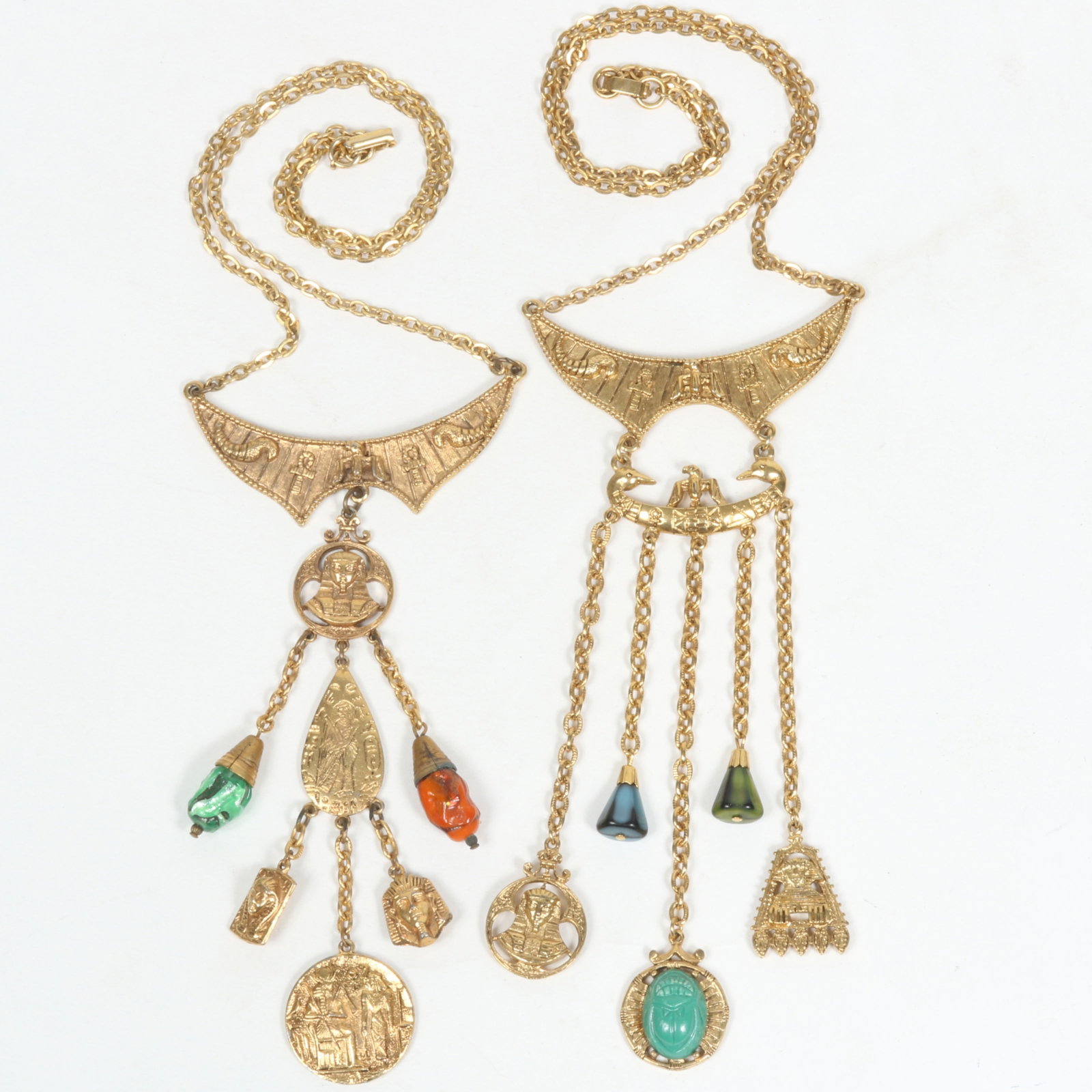 Pair of large ART Egyptian Revival dangle necklaces. 21 1/2" x 5 7/8"Drop (both): Pair of large ART Egyptian Revival dangle necklaces. Provenance: From the collection of Cheryl Killmer. 21 1/2" x 5 7/8"Drop (both)