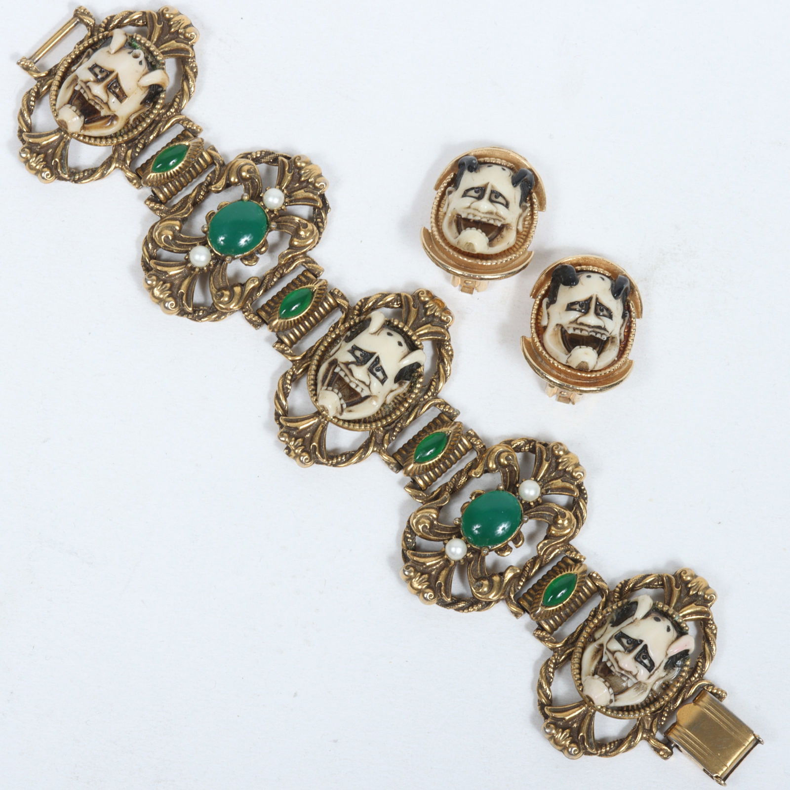 Florenza Unsigned Vintage gilt bass and carved resin Noh Shiro Hannya Japanese Theatre Mask Bracelet: Florenza Unsigned Vintage gilt bass and carved resin Noh Shiro Hannya Japanese Theatre Mask Bracelet and Matching Earrings. Provenance: From the collection of Cheryl Killmer. 7 3/4" L x 1 3/4" W (Brac