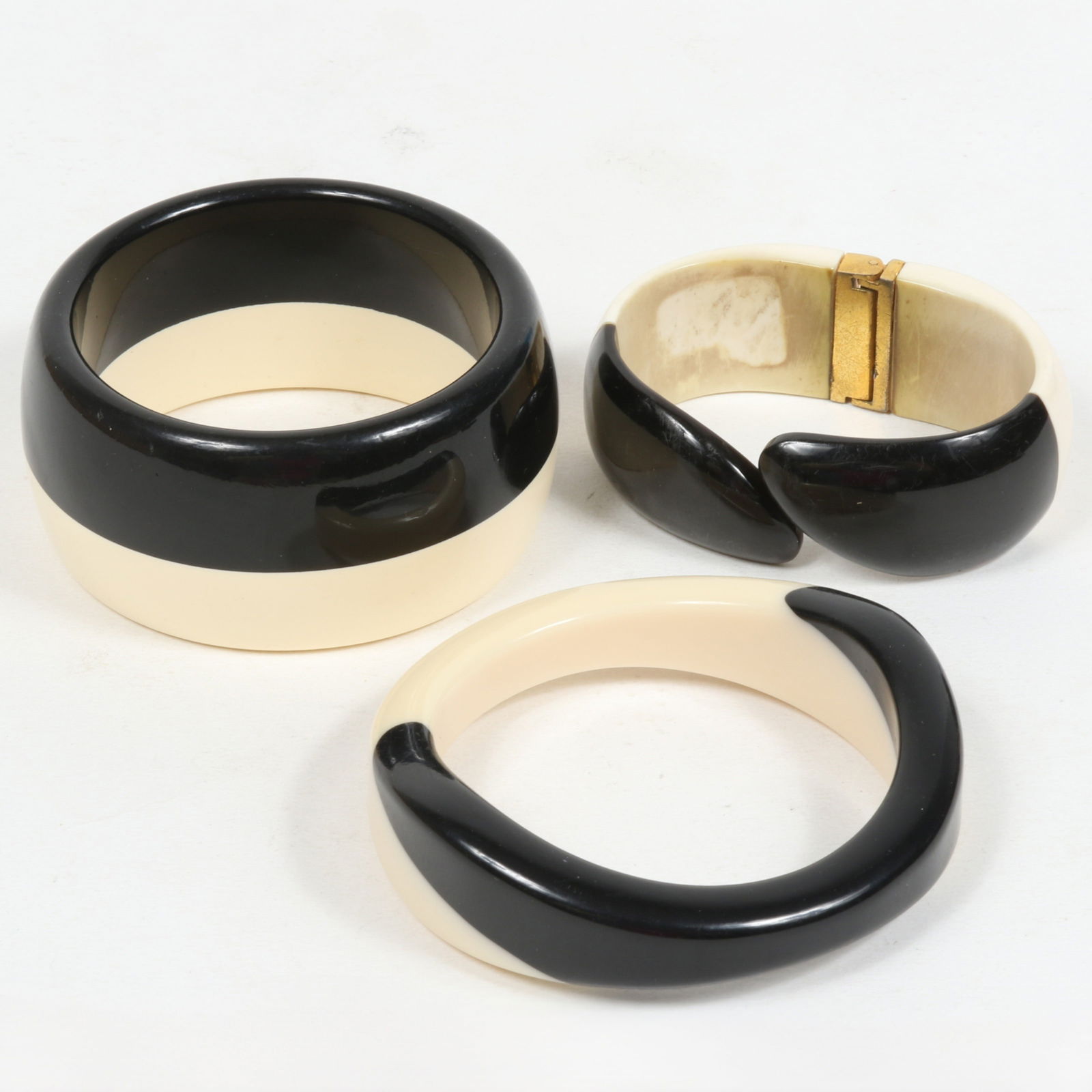 Vintage early plastics black and white pair of bangle bracelets and clamper bracelet. 1 1/2"H x 2 (1 of 7)