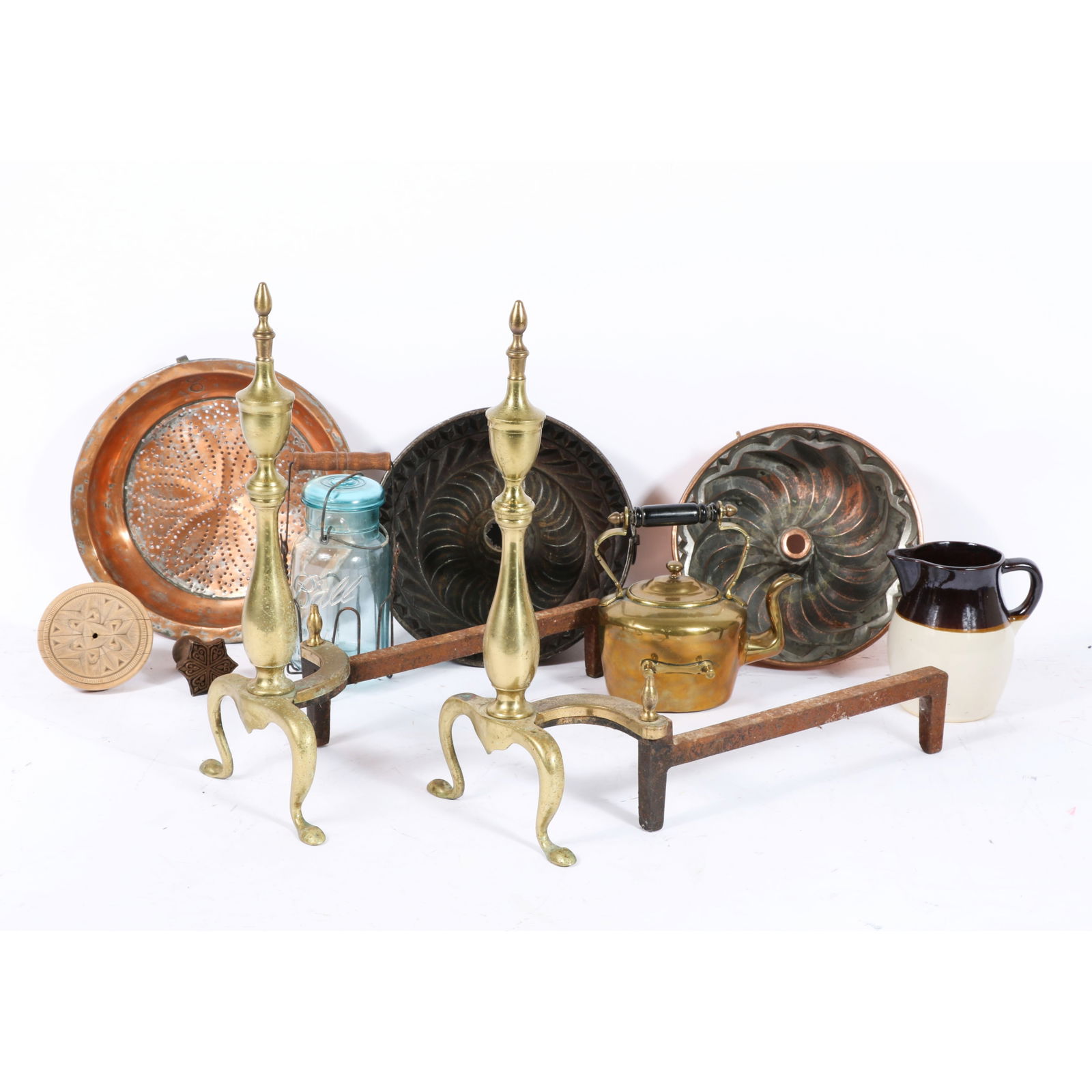 Collection of kitchen objects and a pair andirons: 2 copper cake pudding jello molds, Ball mason jar: Collection of kitchen objects and a pair andirons: 2 copper cake pudding jello molds, Ball mason jar with wire caddy, Roseville Pottery pitcher jug, two wooden butter press stamps, brass tea kettle po