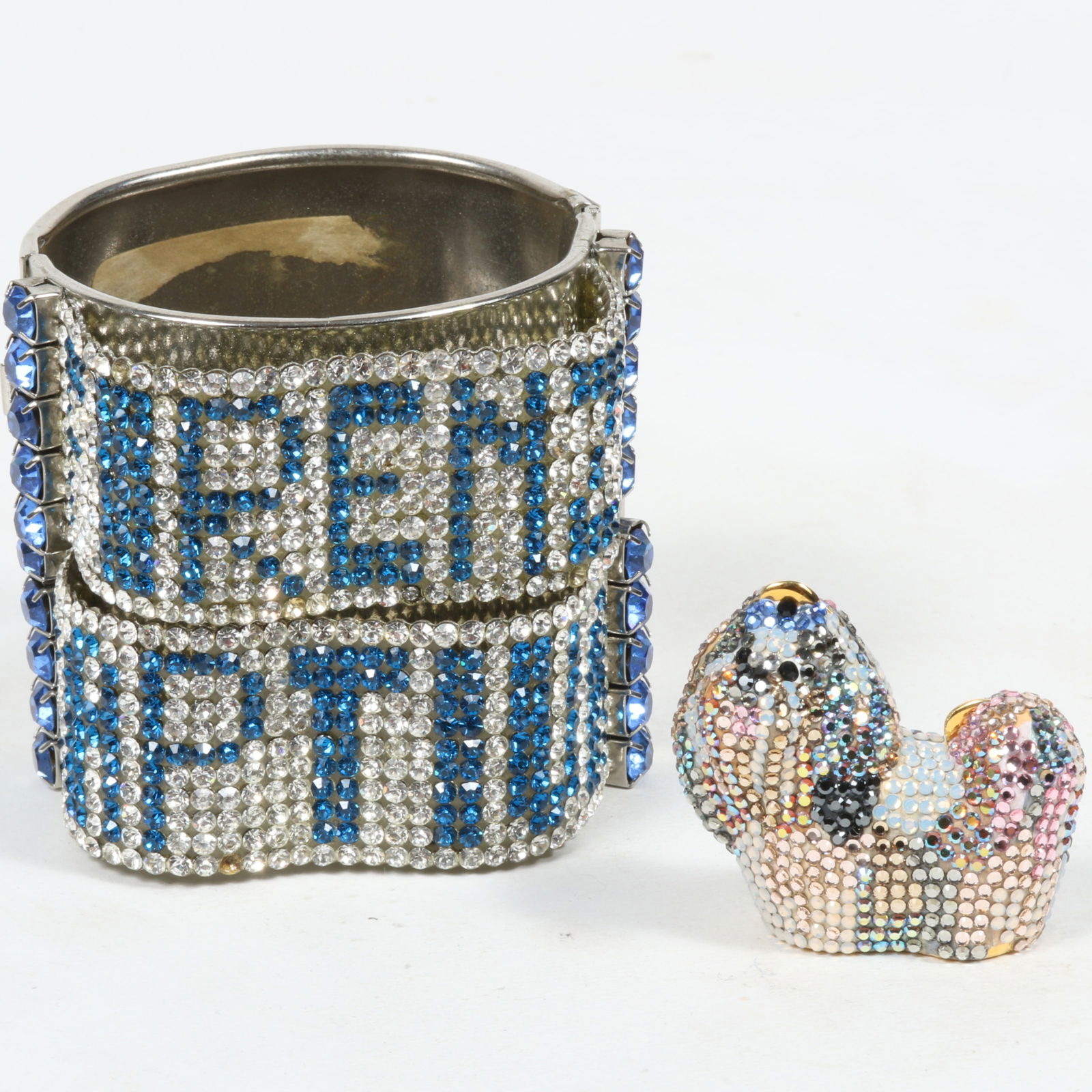 Judith Leiber Shih Tzu dog micro crystal compact pill box in original bag with pair of Demaria Italy: Judith Leiber Shih Tzu dog micro crystal compact pill box in original bag with pair of Demaria Italy silver tone clamper cuffs with blue and clear rhinestones spelling "Forenza" and "Captiva". All hav
