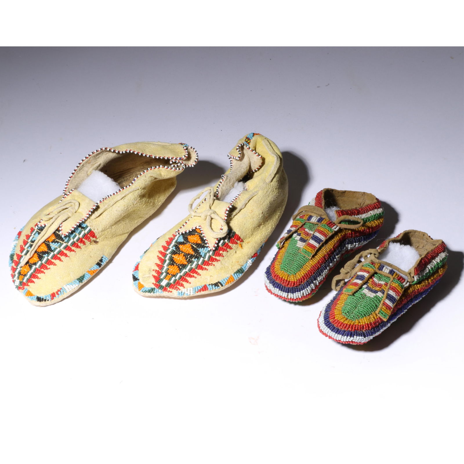 2 pair Plains beaded moccasins Pair 1: 9 1/4" long x 3 1/4" wide x 4 1/4" high, Pair 2: 6 1/2" long (1 of 12)