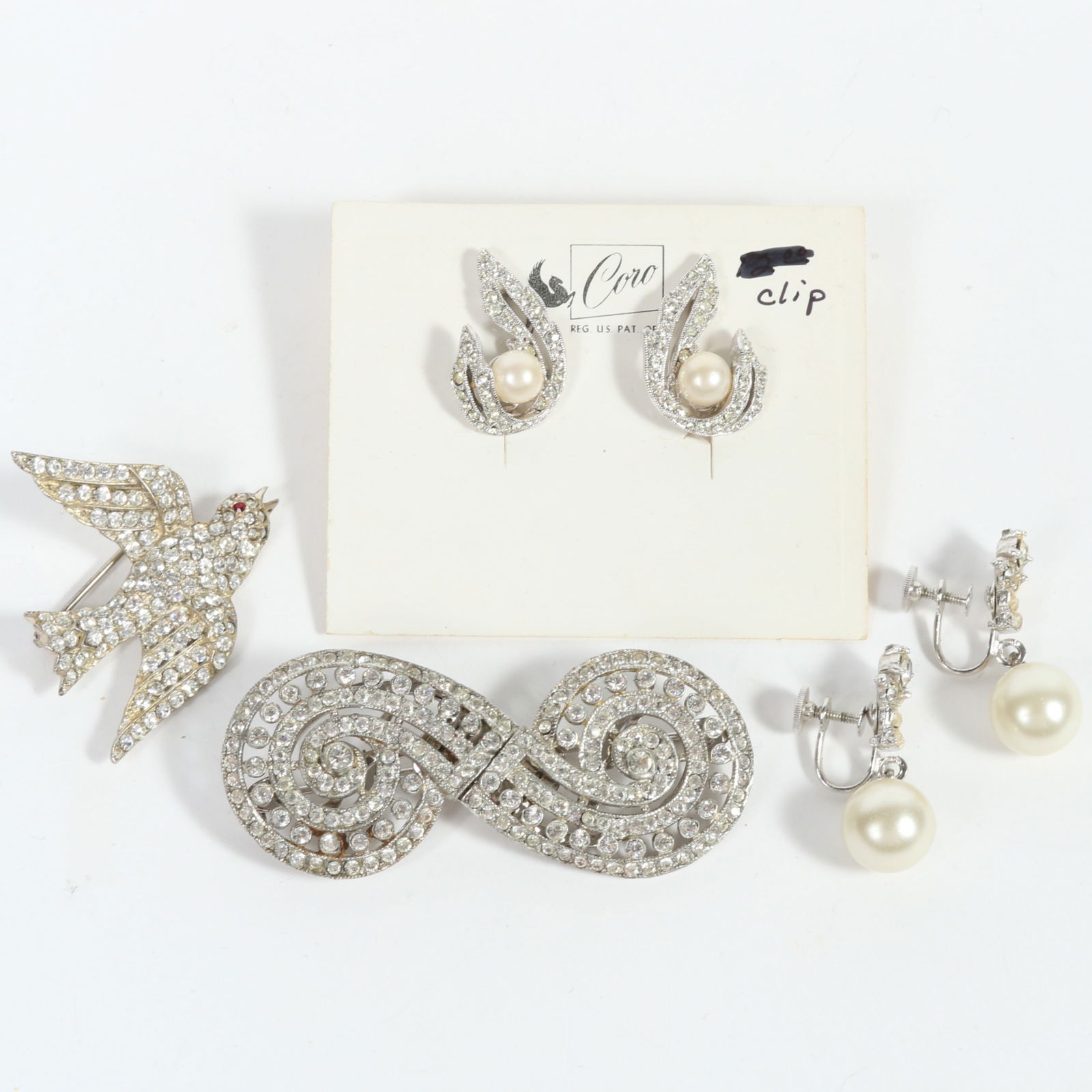 Coro 4pc group including: swirl design rhinestone Coro Duette dress clips, sterling silver: Coro 4pc group including: swirl design rhinestone Coro Duette dress clips, sterling silver rhinestone bird brooch, and two pairs of faux pearl and rhinestone earrings. One Pair of earrings has origina