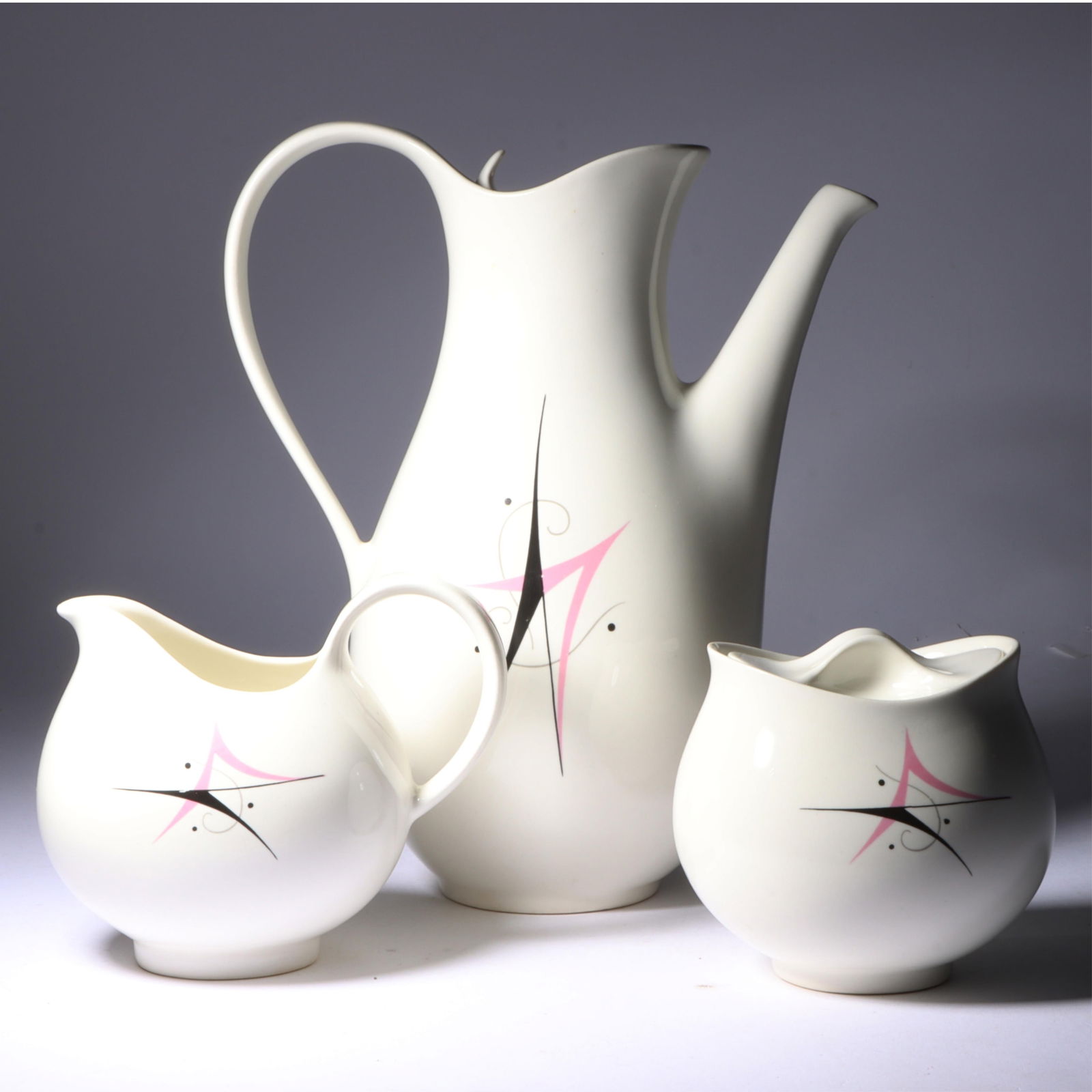 Eva Zeisel Hallcraft Harlequin MCM 3pc ceramic dish group: coffee pot, creamer, sugar bowl. 9 1/4"H: Eva Zeisel Hallcraft Harlequin MCM 3pc ceramic dish group: coffee pot, creamer, sugar bowl. Chip on rim of sugar bowl. 9 1/4"H x 8"W x 4"D (coffee pot)