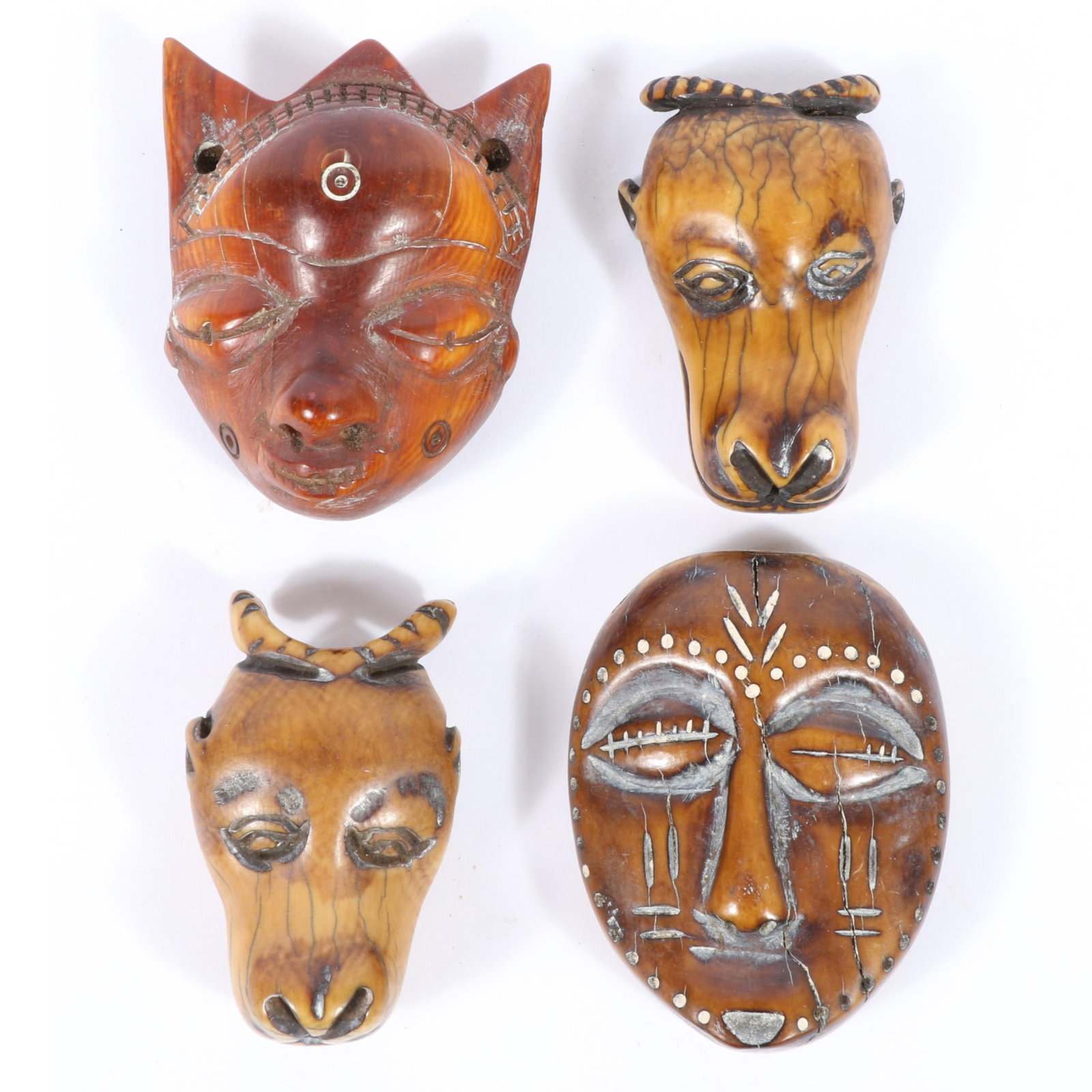 Four African Lega carved mask pendants, D.R. Congo. 3"H x 2"W x 1 1/4"D (largest) (1 of 6)
