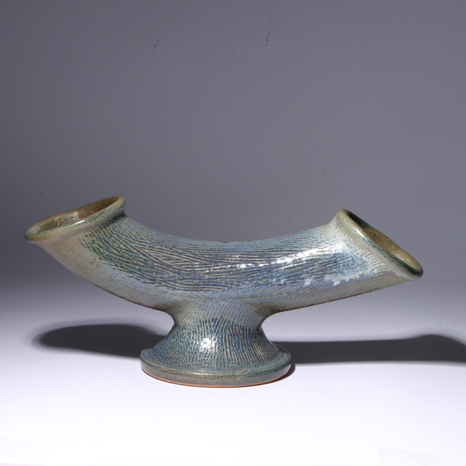 Don (Donald) Reitz, American (1929 - 2014), double ended horizontal cornucopia studio pottery vase,: Don (Donald) Reitz American (1929 - 2014) double ended horizontal cornucopia studio pottery vase glazed stoneware Incised signature under base. Biography from the Archives of askART: "Don Reitz: Clay,