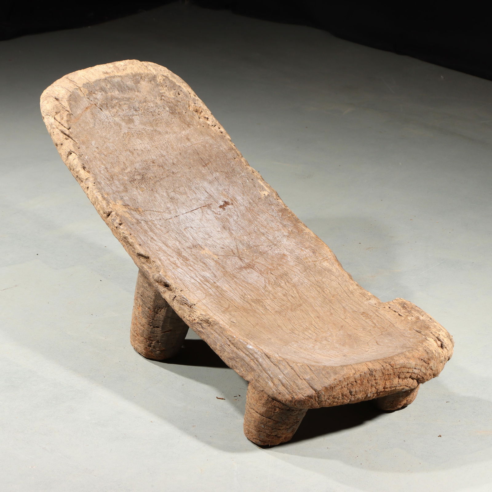 African tribal art; carved wood reclined chair. 16 1/2"H x 14"W x 38"L: African tribal art; carved wood reclined chair. 16 1/2"H x 14"W x 38"L. This lot requires local pickup or third party shipping. Please contact us for a list of third party shippers.