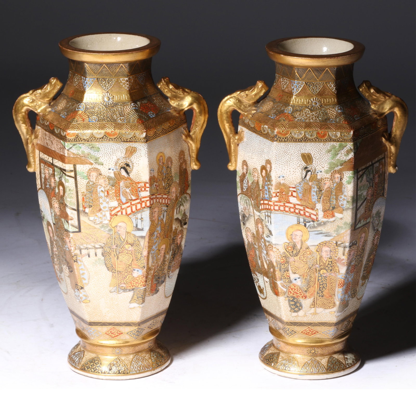 Pair Japanese Satsuma earthenware octagonal vases with scenic monk figures and dragon handles, 19th (1 of 14)