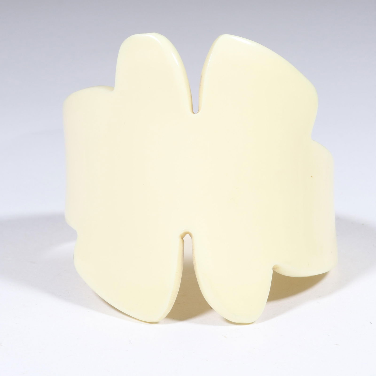 Unsigned Isabel Canovas? faux ivory celluloid freeform cuff bracelet. 2 7/8"H x 2 1/2"Inner Diameter: Unsigned Isabel Canovas? faux ivory celluloid freeform cuff bracelet. Very light scratching to surface. 2 7/8"H x 2 1/2"Inner Diameter