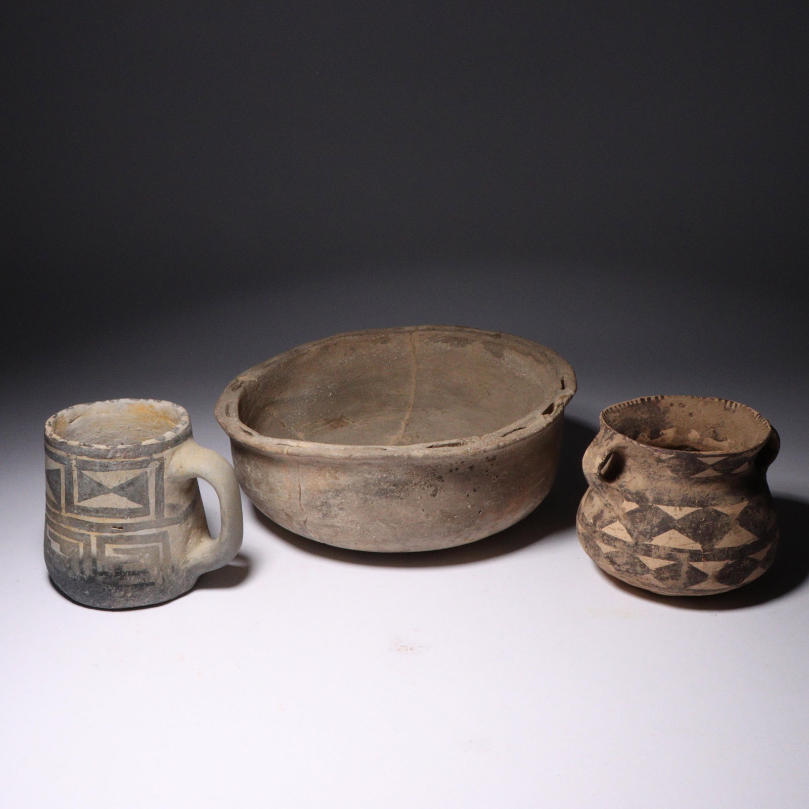 Three prehistoric Anasazi Native American polychrome pottery vessels: mug, bowl, and double handled (1 of 6)
