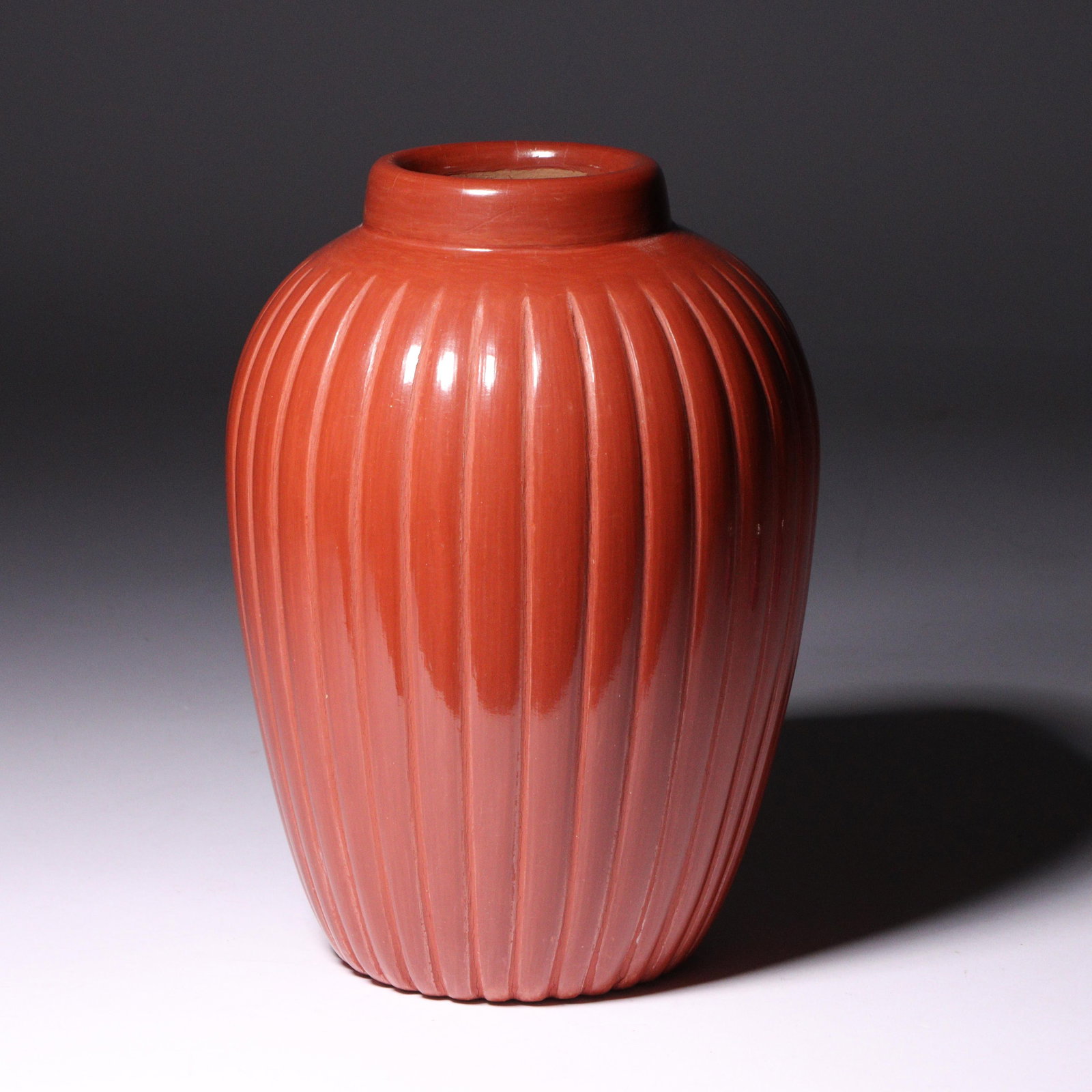 Alvin Baca (Native American, b. 1966) Santa Clara redware melon pottery vase 6 1/4"H x 4 1/2"W: Alvin Baca (Native American, b. 1966) Santa Clara redware melon pottery vase From the private collection of Bret Waller and Mary Lou Dooley Waller, Indianapolis, Indiana. 6 1/4"H x 4 1/2"W