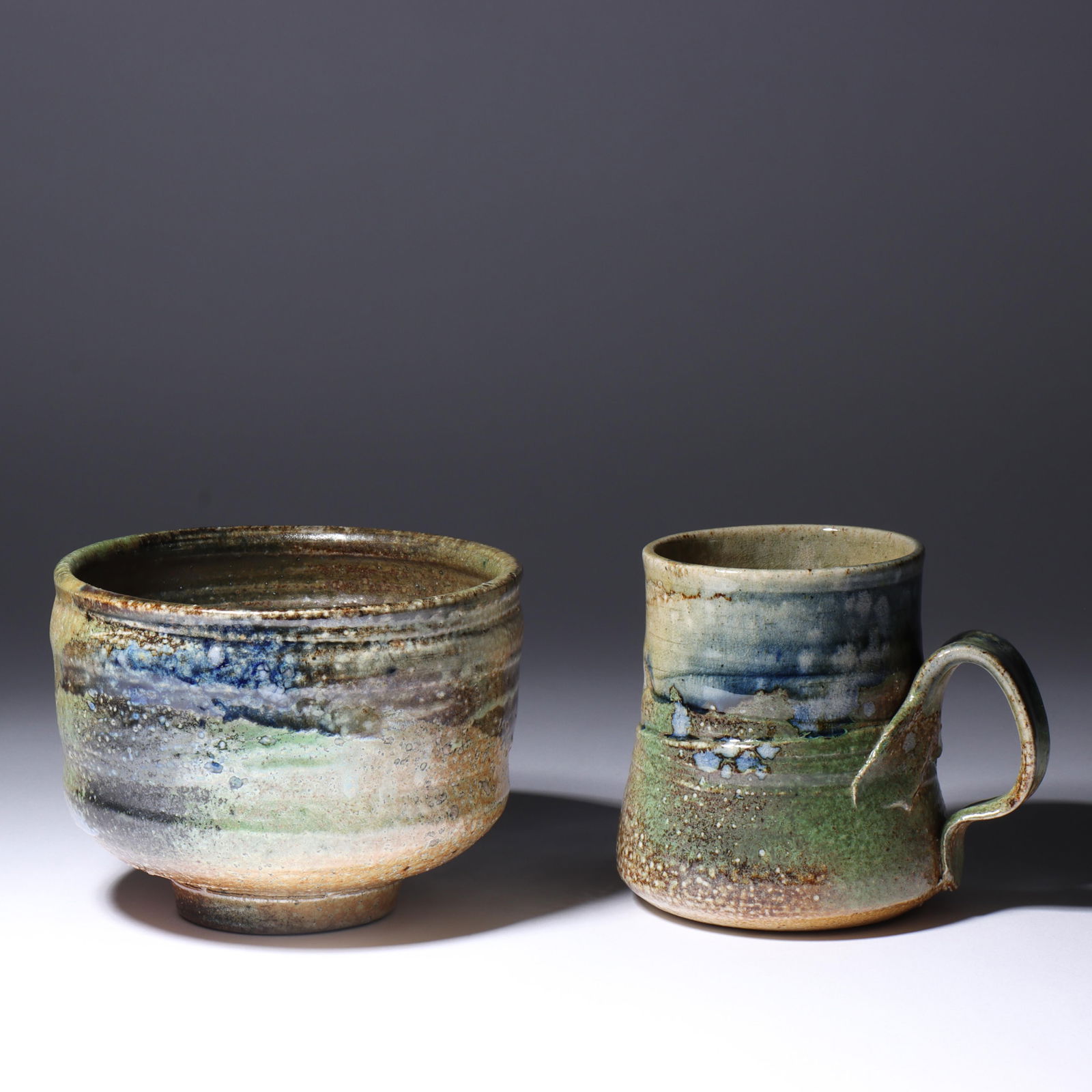 Don (Donald) Reitz, American (1929-2014), art pottery mug and bowl, stoneware, 3 3/4"H x 5"Diam.: Don (Donald) Reitz American (1929-2014) art pottery mug and bowl stoneware Both signed under base. Biography from the Archives of askART: "Don Reitz: Clay, Fire, Salt, and Wood" by Jody Clowes Fearles