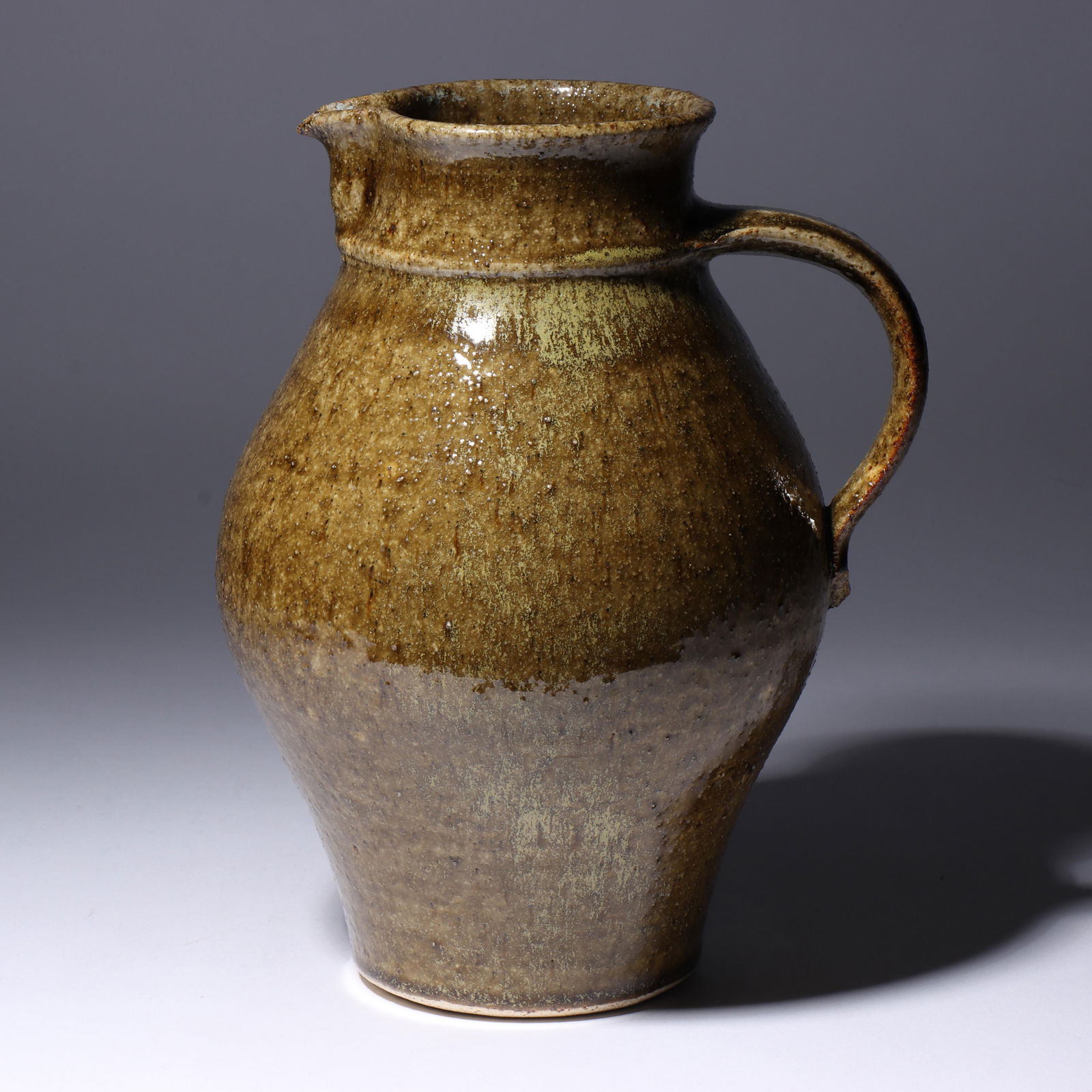 Don (Donald) Reitz, American (1929-2014), studio pottery pitcher, glazed stoneware, 10"H x 6"Diam.: Don (Donald) Reitz American (1929-2014) studio pottery pitcher glazed stoneware Signed under base. Biography from the Archives of askART: "Don Reitz: Clay, Fire, Salt, and Wood" by Jody Clowes Fearles