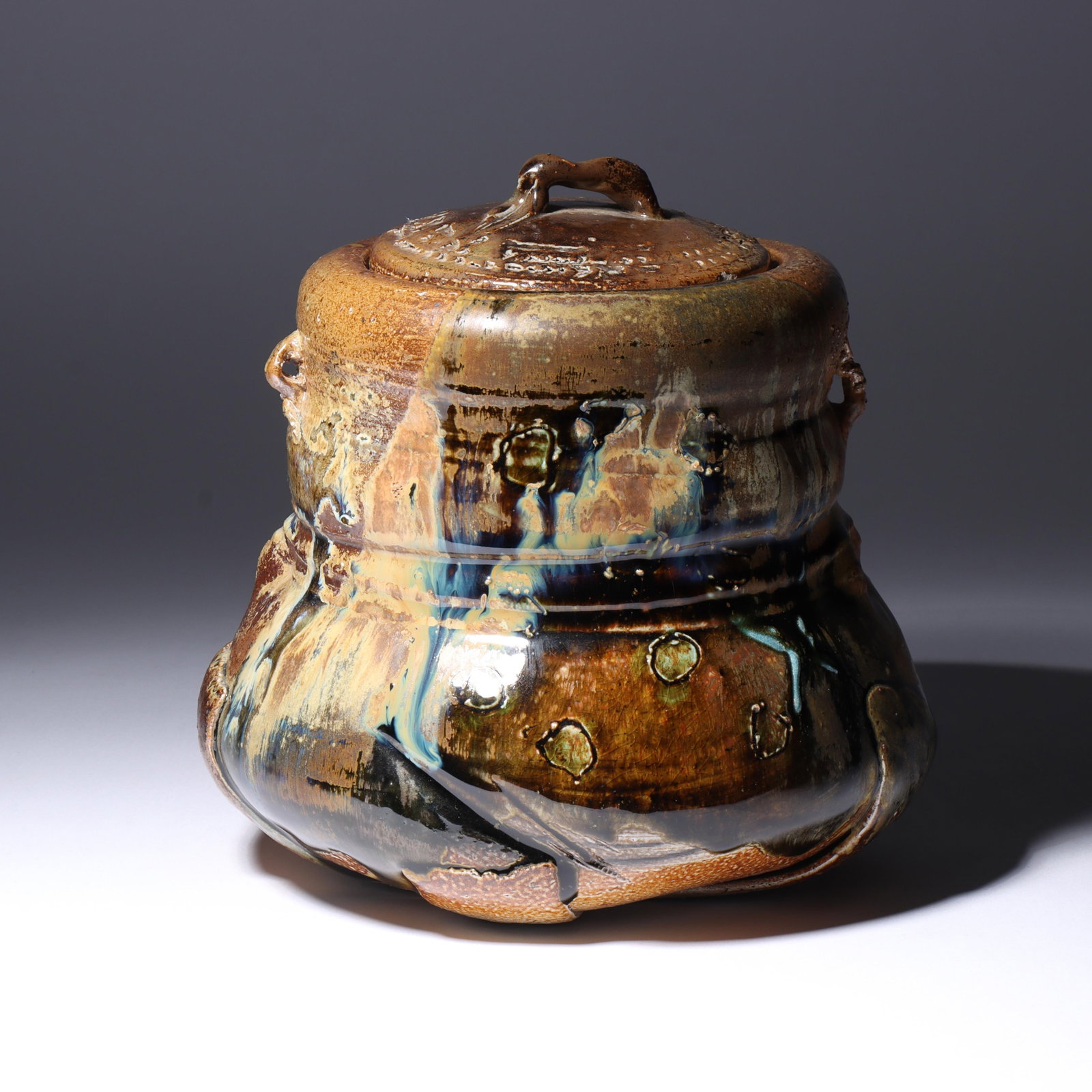 Don (Donald) Reitz, American (1929-2014), art pottery lidded jar, stoneware, 7 1/2"H x 7"Diam. (with: Don (Donald) Reitz American (1929-2014) art pottery lidded jar stoneware Signed under base. Biography from the Archives of askART: "Don Reitz: Clay, Fire, Salt, and Wood" by Jody Clowes Fearless impro