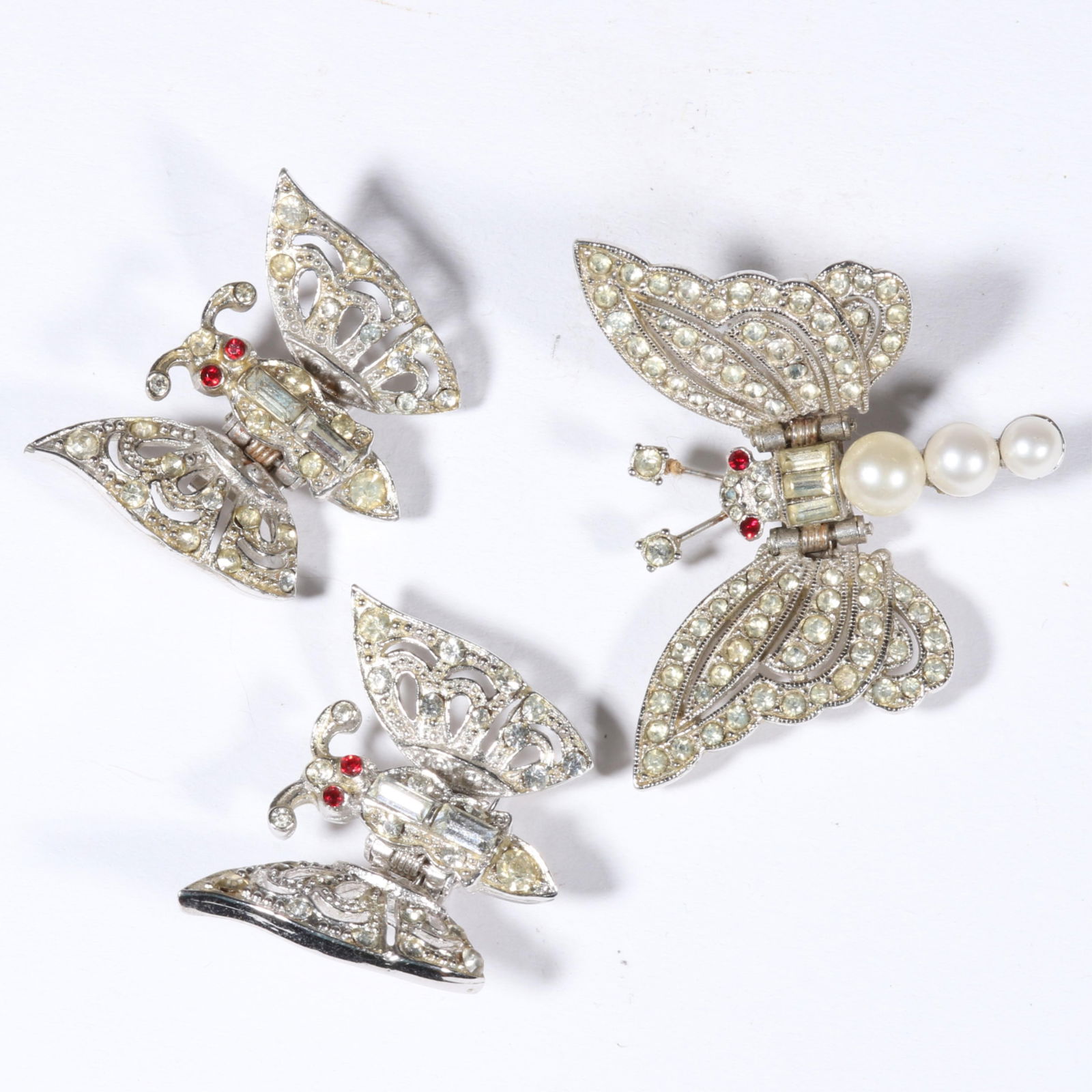 Pair of Coro diamante rhinestone crystal articulated butterfly clips with unsigned faux pearl: Pair of Coro diamante rhinestone crystal articulated butterfly clips with unsigned faux pearl butterfly clip. Provenance: From the collection of Cheryl Killmer. 1 5/8"H x 1 3/4"W (unsigned clip)