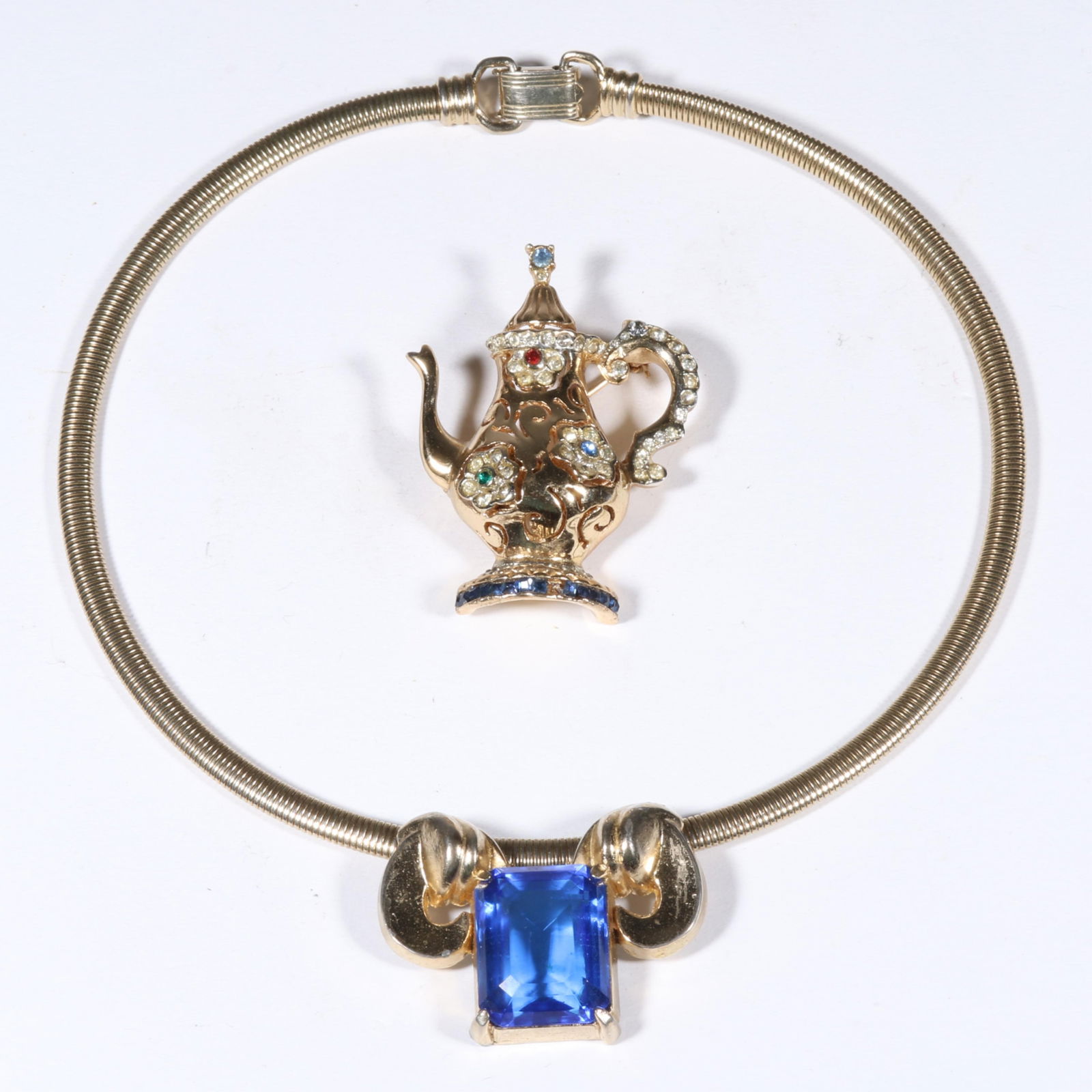 Coro 2pc group: retro blue rhinestone jewel necklace and multi color jeweled teapot coffeepot: Coro 2pc group: retro blue rhinestone jewel necklace and multi color jeweled teapot coffeepot brooch. Provenance: From the collection of Cheryl Killmer. 15"L x 1 1/4"W (necklace)