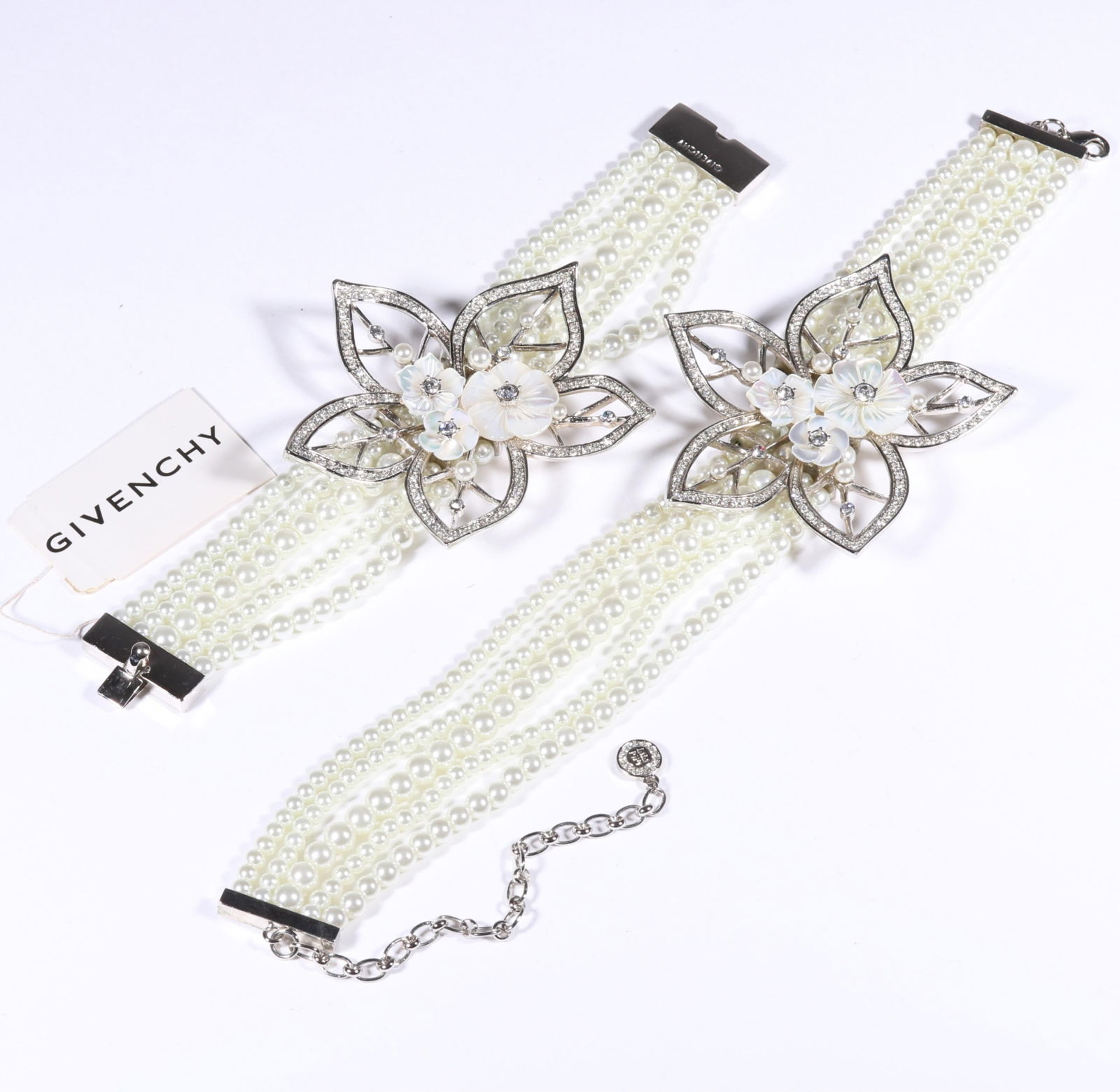 Givenchy designer couture multistrand faux pearl choker necklace and matching bracelet with large: Givenchy designer couture multistrand faux pearl choker necklace and matching bracelet with large floral accents. With original tag. Provenance: From the collection of Cheryl Killmer. 15"L x 2 7/8"W (