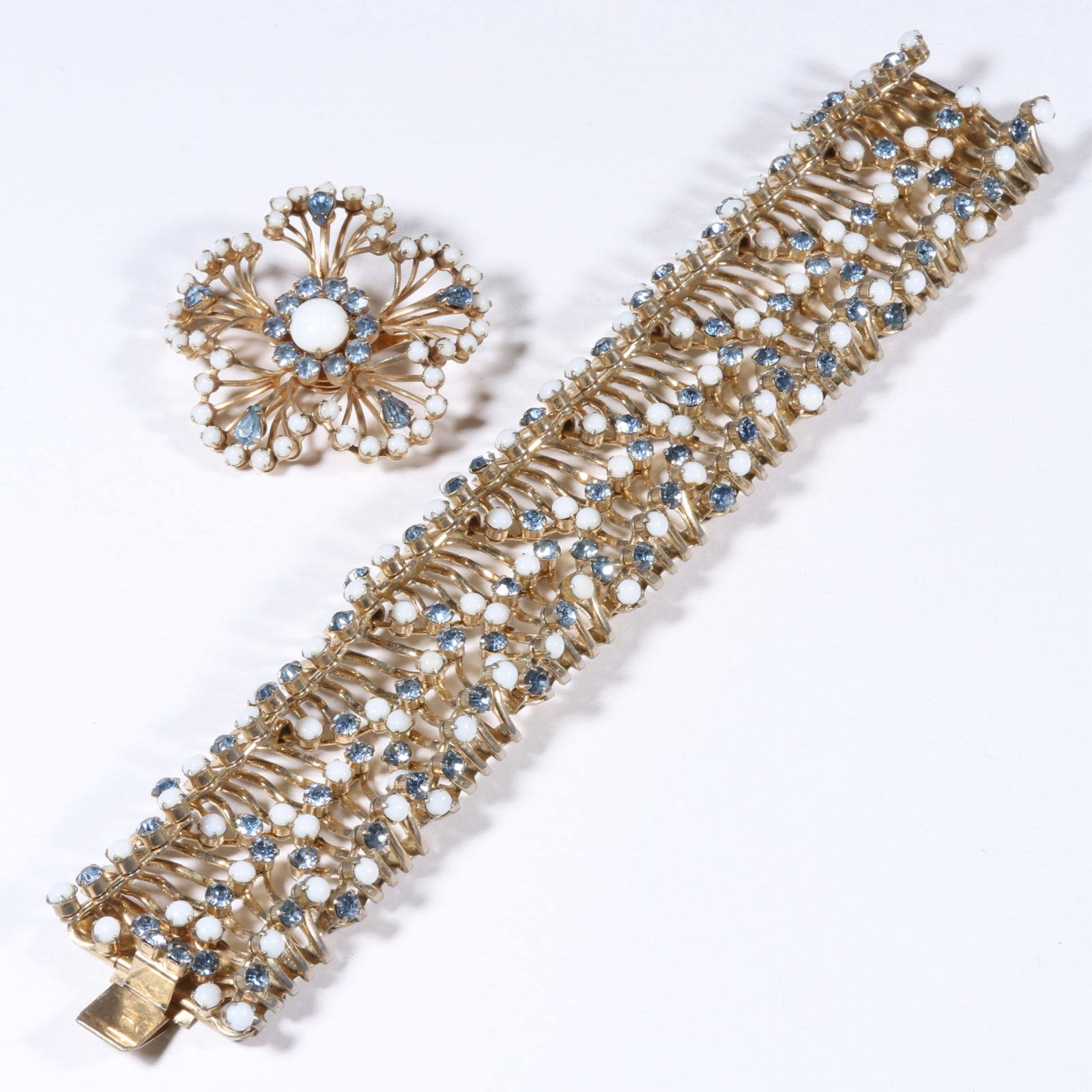 Hattie Carnegie intricate dimensional rhinestone crystal bracelet and matching brooch. 7 1/2"L x 1: Hattie Carnegie intricate dimensional rhinestone crystal bracelet and matching brooch. Provenance: From the collection of Cheryl Killmer. 7 1/2"L x 1 1/4"W (bracelet)