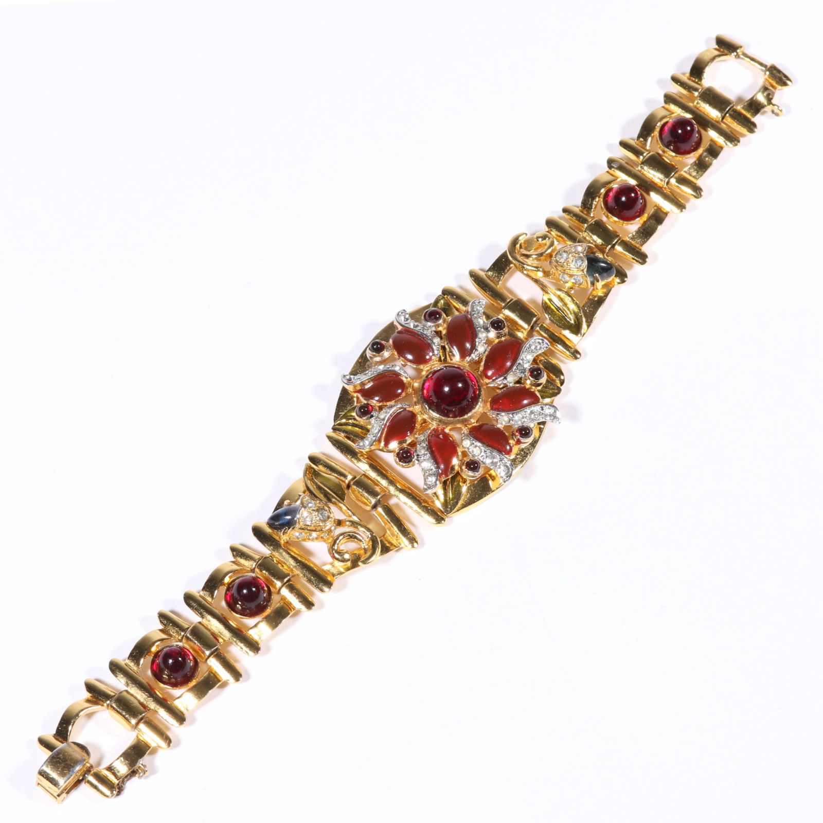 Unsigned Coro Carmen Miranda Retro bracelet with enamel flower, jewel toned cabochons and rhinestone: Unsigned Coro Carmen Miranda Retro bracelet with enamel flower, jewel toned cabochons and rhinestone crystals. Safety chain is broken. Provenance: From the collection of Cheryl Killmer. 7 3/8"L x 1 3/