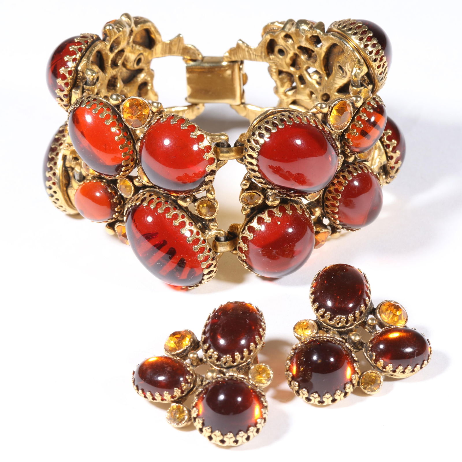 Unsigned Selro Selini rich orange jelly cabochon panel bracelet and matching earrings. 7 1/2"L x 1: Unsigned Selro Selini rich orange jelly cabochon panel bracelet and matching earrings. Provenance: From the collection of Cheryl Killmer. 7 1/2"L x 1 3/4"W (bracelet)