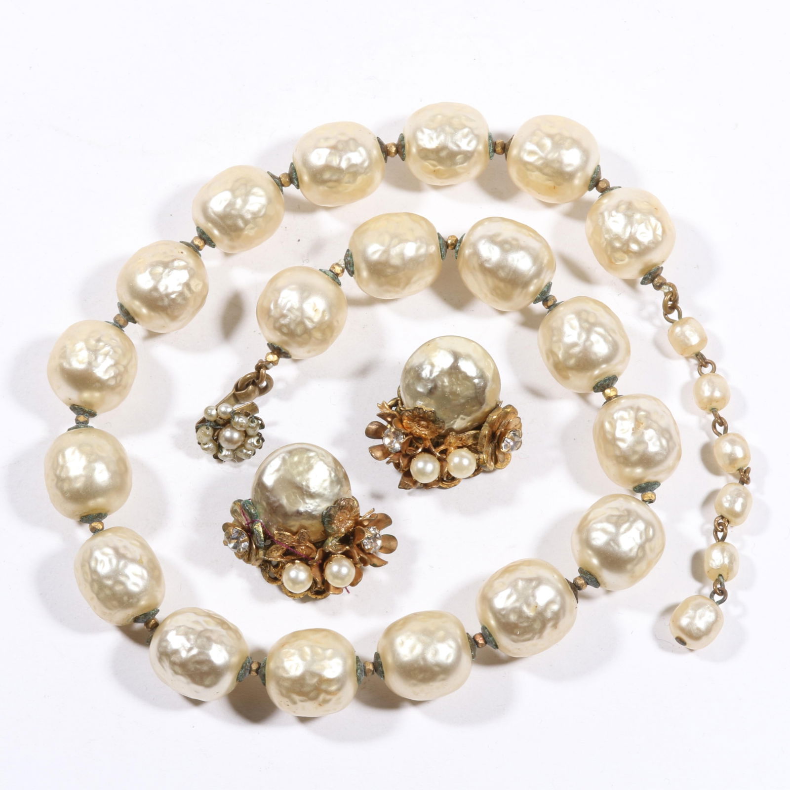 Miriam Haskell baroque pearl single strand necklace with seed bead clasp and Haskell earrings. 17"L: Miriam Haskell baroque pearl single strand necklace with seed bead clasp and Haskell earrings. Necklace has partly bent clasp and minor loss of pearl coating. 17"L x 5/8"W (necklace)