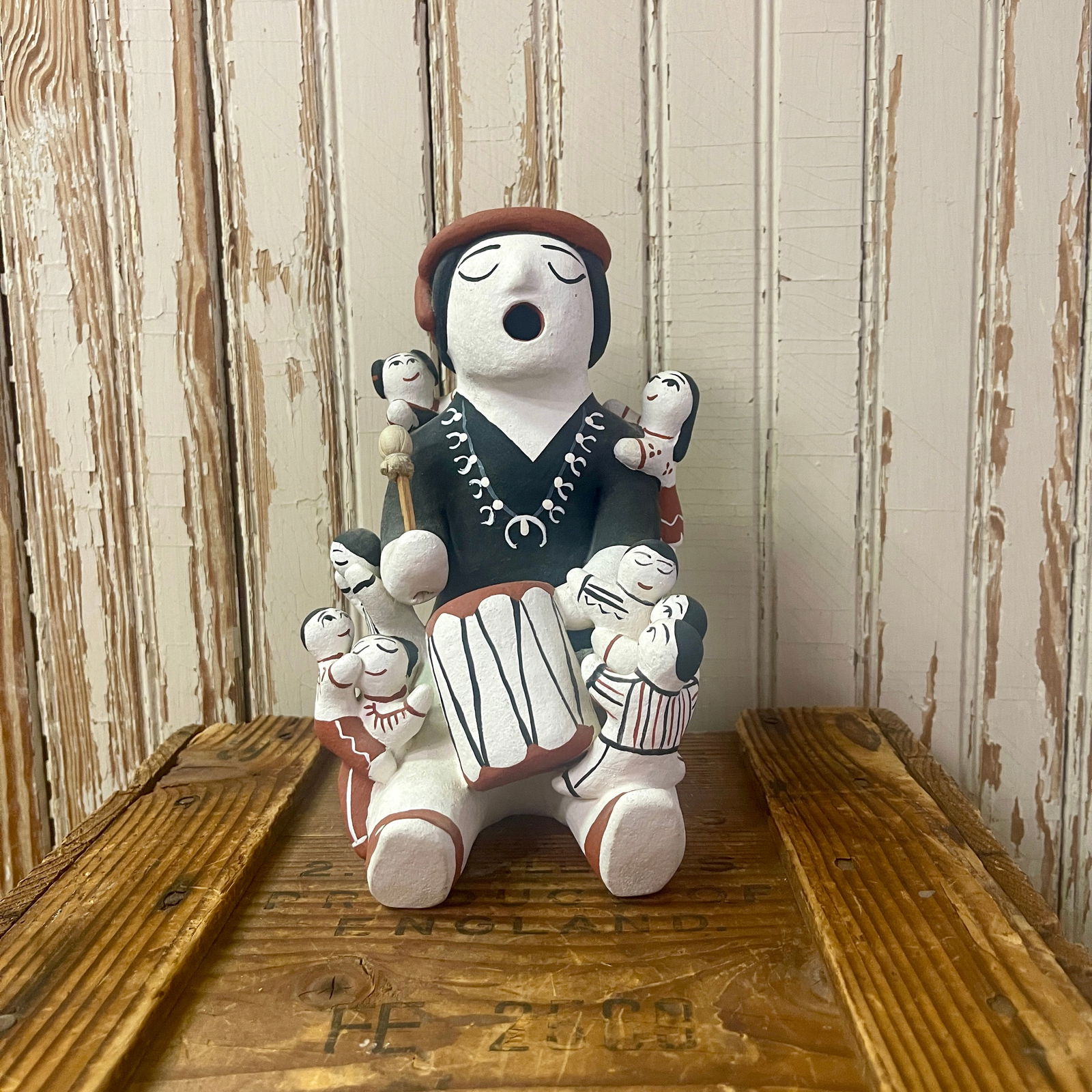 Storyteller with 8 children and 1 baby 8" high, 6" wide, 7" deep: Storyteller with 8 children and 1 baby storyteller with 8 children and 1 baby, squash blossom necklace and drum, signed Hummingbird 8" high, 6" wide, 7" deep very good condition 8" high, 6" wide, 7" d