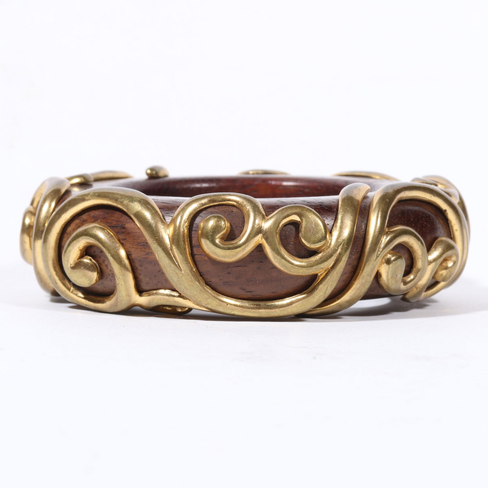 Unsigned Isabel Canovas chunky wooden bangle with applied gilt brass swirl patterns. 1 1/8"H x 2: Unsigned Isabel Canovas chunky wooden bangle with applied gilt brass swirl patterns. 1 1/8"H x 2 1/2"Inner Diameter