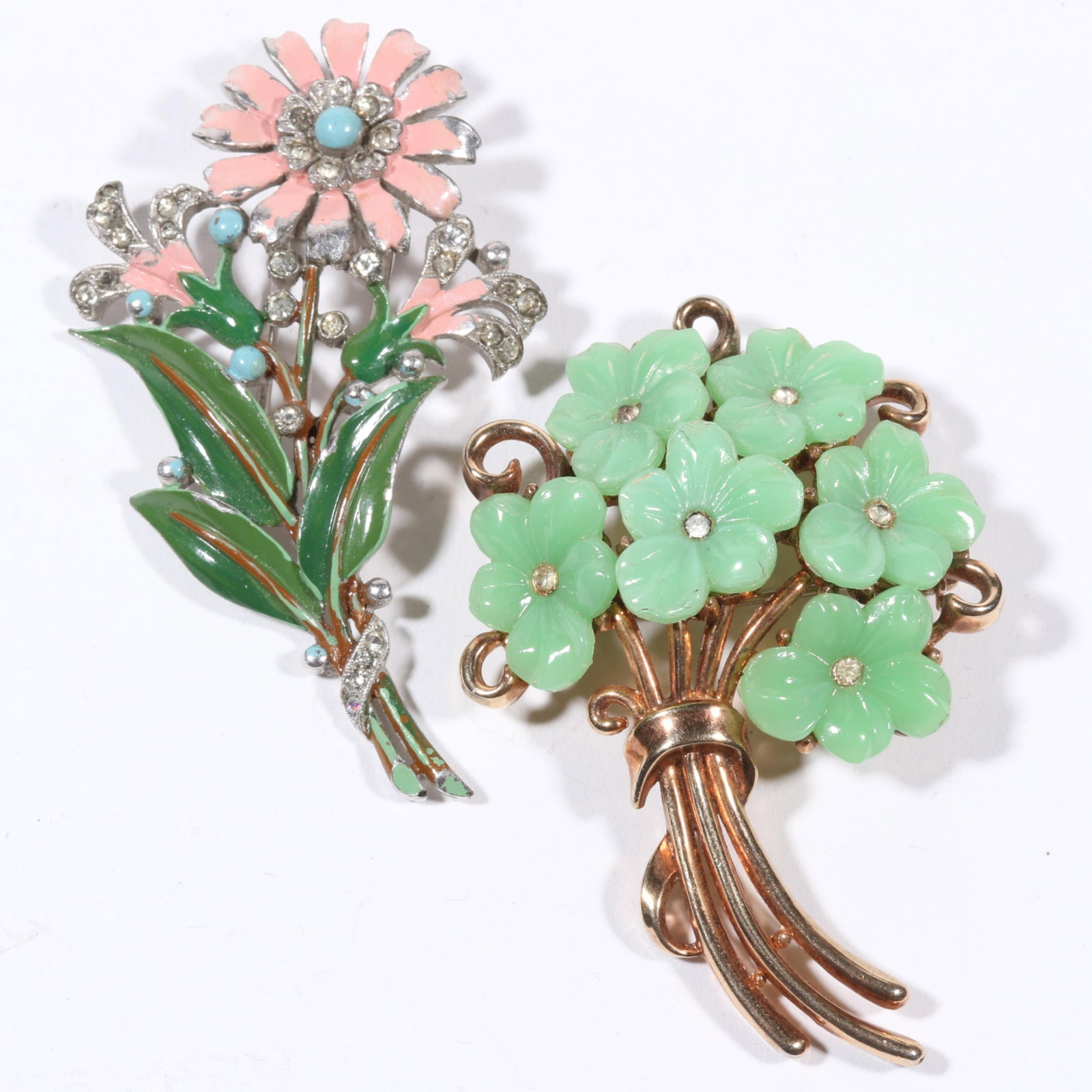 Retro Crown Trifari enamel and rhinestone crystal pink flower fur clip and green molded glass flower: Retro Crown Trifari enamel and rhinestone crystal pink flower fur clip and green molded glass flower brooch. Wear to enamel and few light chips on green glass flowers. 2 1/2"H x 1 3/4"W (largest brooc