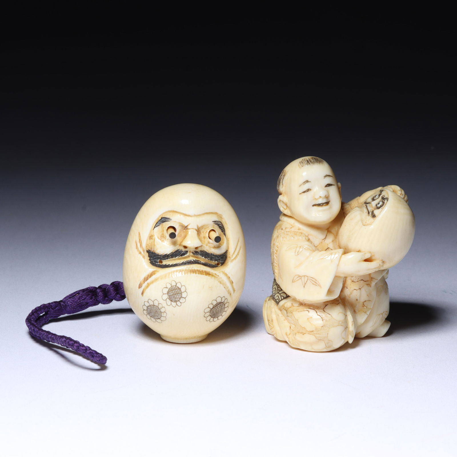 Japanese carved figural netsuke 2pc group: smiling boy holding mask of fierce expression (jealousy), (1 of 11)
