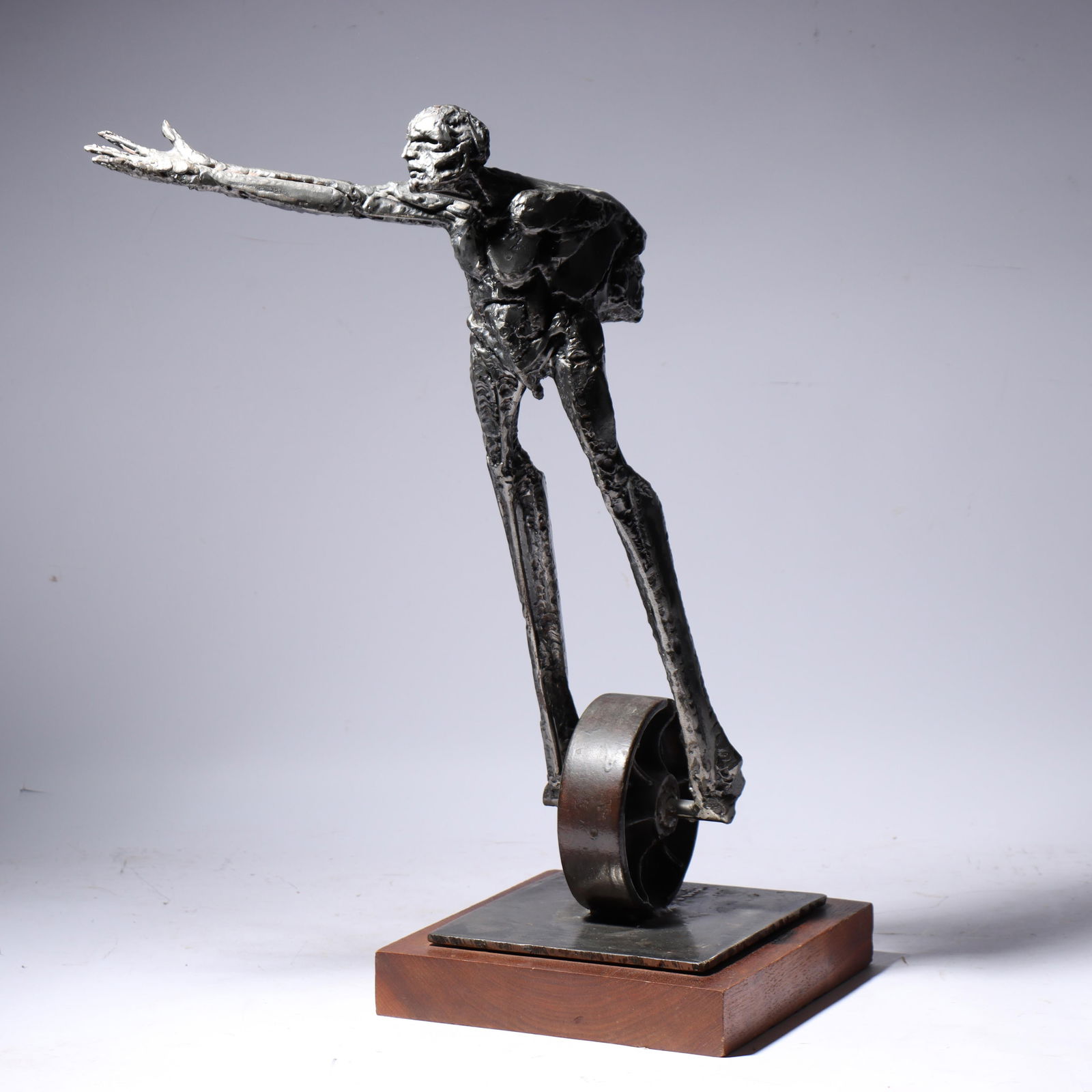 Theodore Gall, California / Illinois (b.1941), figure on a wheel, 1976, steel sculpture, 24"H x 13"W: Theodore Gall California / Illinois (b.1941) figure on a wheel, 1976 steel sculpture signed / engraved to base. Biography from the Archives of askART: Showing an early aptitude for art, Ted Gall's mot