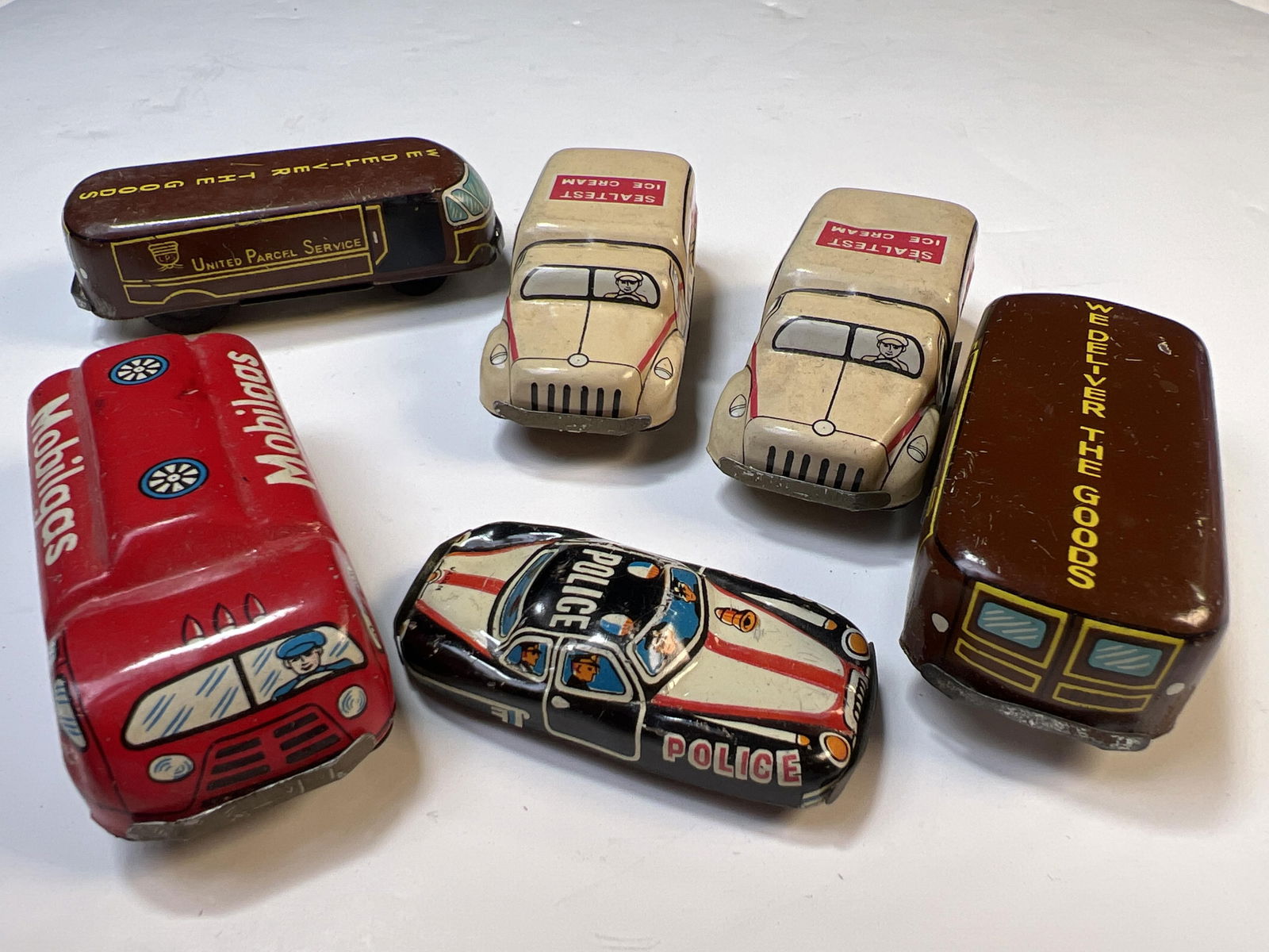 6 antique toy tin cars with advertising for Mobil, UPS, Sealtest, and the police, Elvin, Japan, (1 of 8)