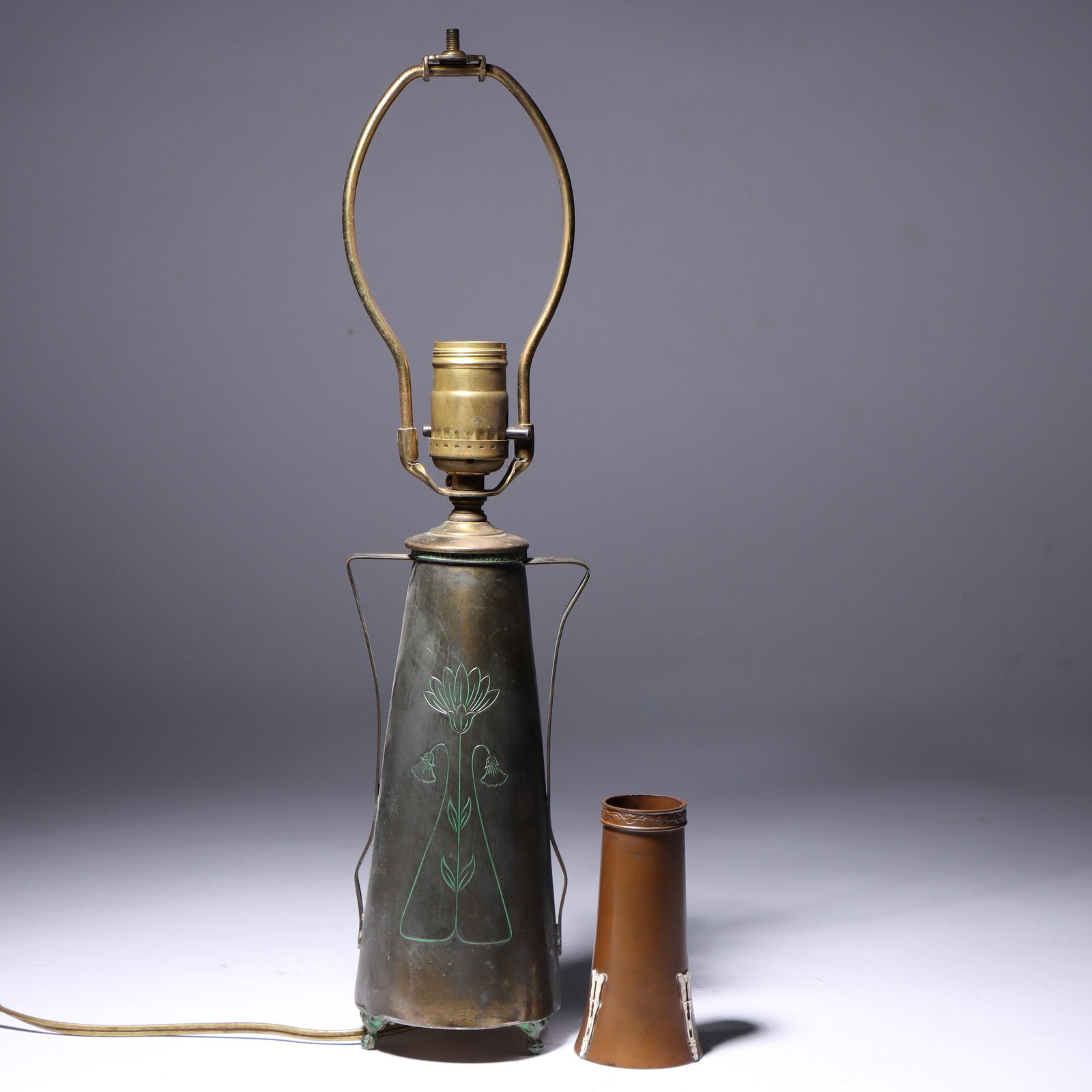 Egyptian Inspired Lamp and a Bronze Vase 9"H (w/o harp), 3 1/2"Diam. (Lamp): Egyptian Inspired Lamp and a Bronze Vase Brass plated metal handled lamp w/ 3 claw ftd. feet; lotus design & enameled border. Vase stamped "Ivory Bronze"-three Egyptian motifs of scarabs and feathers