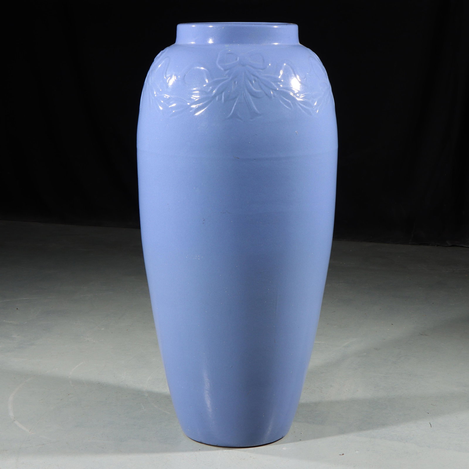 Bungalow Jar 26"H x 11"Diam.: Bungalow Jar Unmarked Robinson Ransbottom Pottery Co. Mauve Blue glazed Bungalow Jar with Ribbon & Bow decoration on rim. Unmarked. Provenance: Charles Alexander, Indianapolis, IN 26"H x 11"Diam.