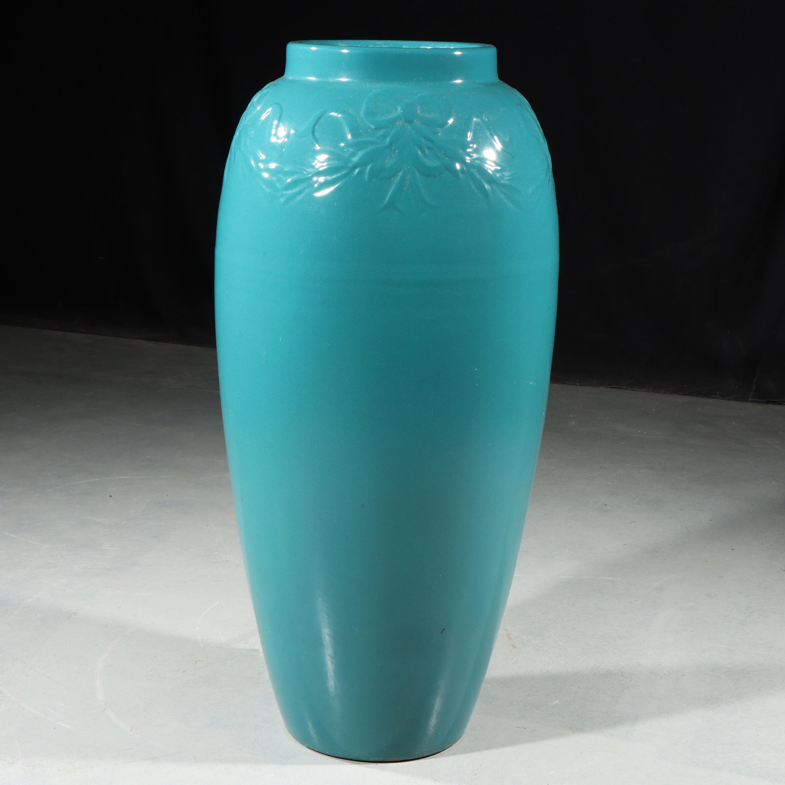 Bungalow Jar 26"H x 11"Diam.: Bungalow Jar Unmarked Robinson Ransbottom Pottery Co. Turquoise Green glazed Bungalow Jar with Ribbon & Bow decoration on rim. Unmarked. Provenance: Charles Alexander, Indianapolis, IN 26"H x 11"Diam.