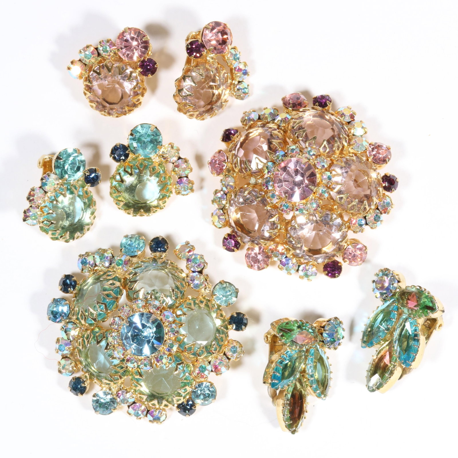 DeLizza & Elster Juliana baby pink and blue foiled and unfoiled rhinestone crystal domed brooches: DeLizza & Elster Juliana baby pink and blue foiled and unfoiled rhinestone crystal domed brooches with matching earrings and pair of complementary Juliana earrings.1 7/8"Diameter (both brooches)
