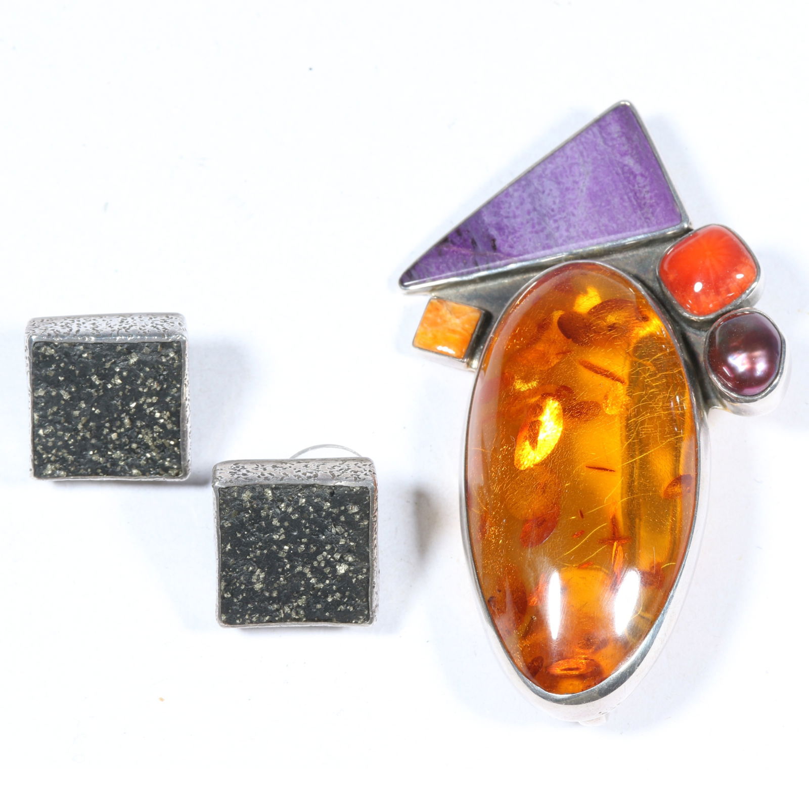 A collection of sterling silver jewelry by Amy Kahn Russell, featuring a pendant brooch with Baltic (1 of 7)