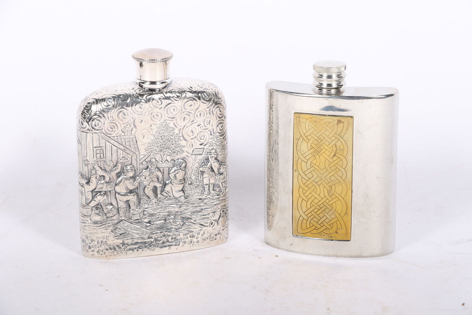Two vintage flasks: Derby SP Co silverplated repousse scenic flask, Edwin Blyde pewter flask with: Two vintage flasks: Derby SP Co silverplated repousse scenic flask, Edwin Blyde pewter flask with brass panel insert featuring a Celtic knot design 5"H x 3 3/4"W (largest)