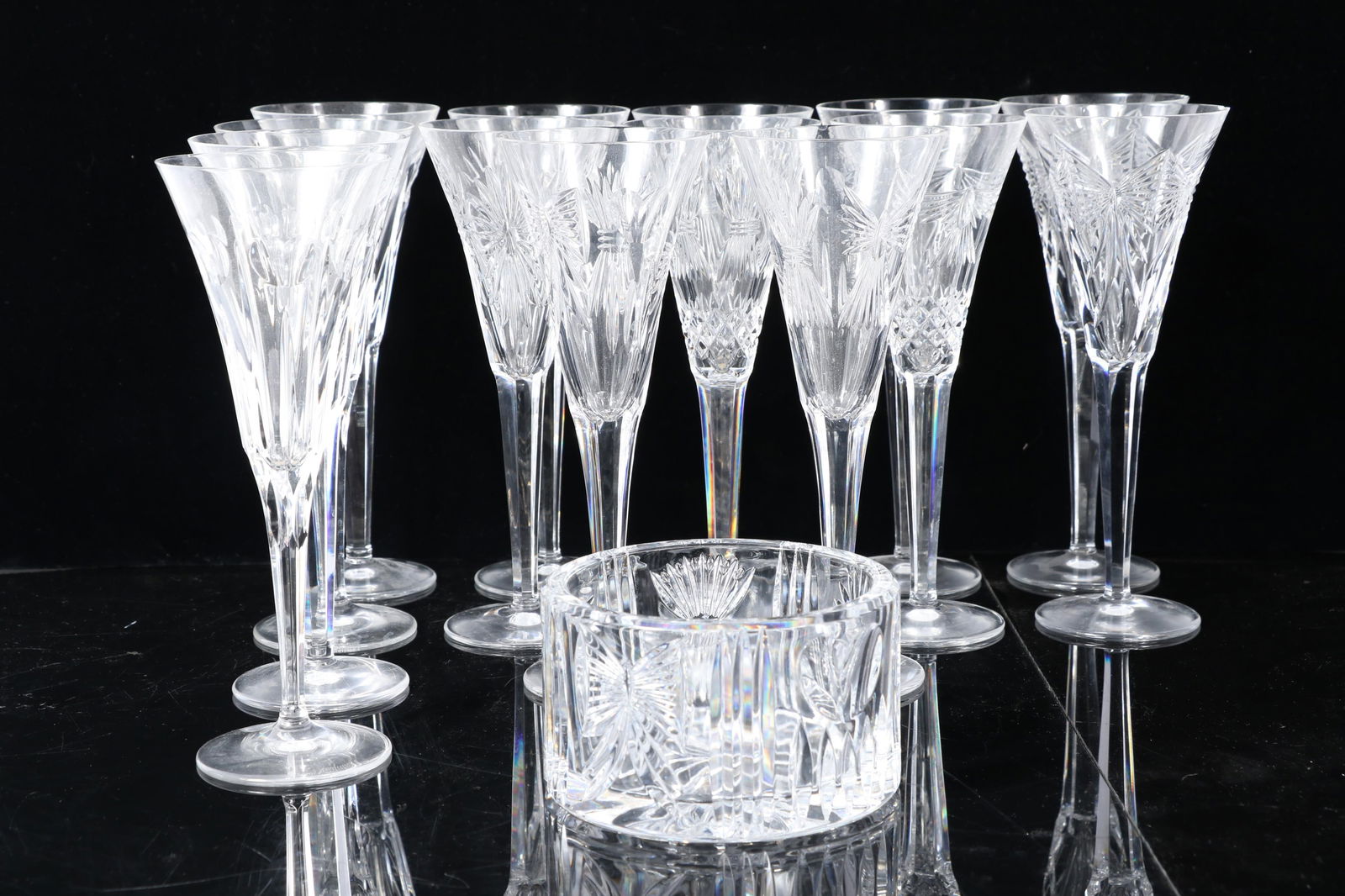 Waterford Crystal Millennium series champagne flutes & champagne/wine bottle coaster, 15pc 9 1/4'H x: Waterford Crystal Millennium series champagne flutes & champagne/wine bottle coaster, 15pc 14 flutes and coaster. Chips present on glass rims. 9 1/4"H x 3 1/2"Diam ( one flute)