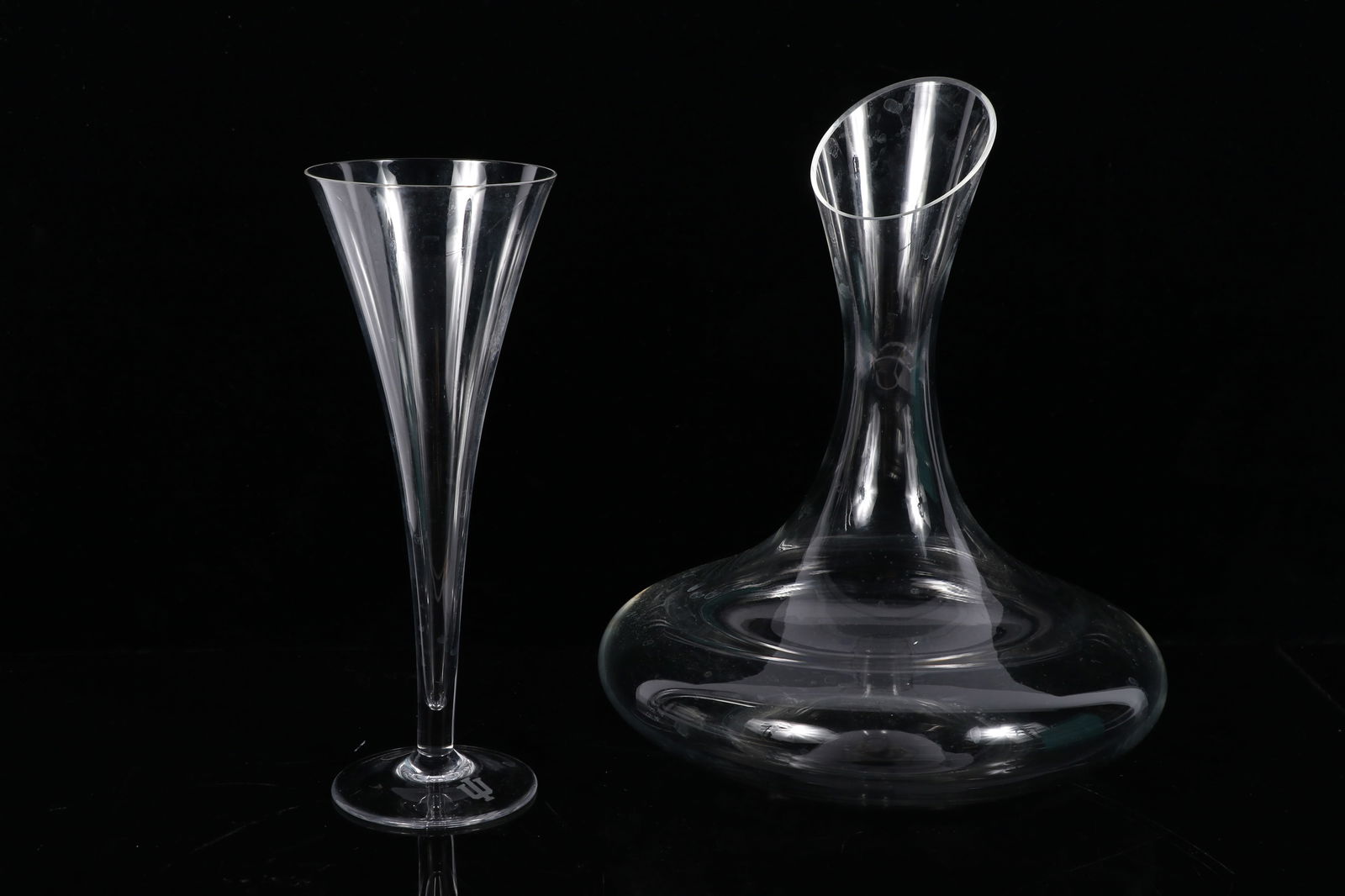 Tiffany & Co / Indiana University IU trident logo crystal trumpet champagne flute and Crate & Barrel: Tiffany & Co / Indiana University IU trident logo crystal trumpet champagne flute and Crate & Barrel "Swoon" wine decanter 10 1/2"H x 8 1/2"Diam. (decanter)