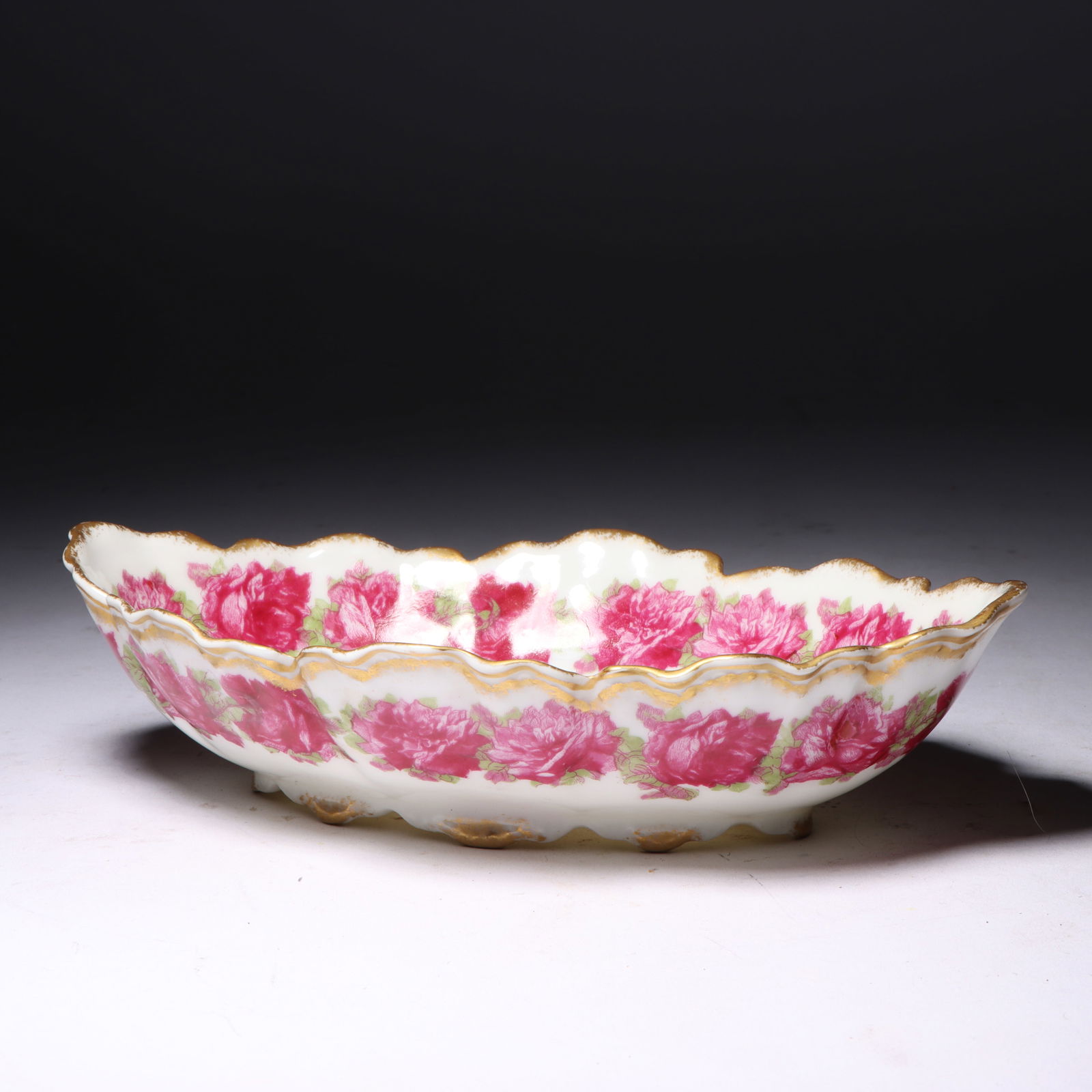 Haviland Limoges drop rose porcelain dish 2 1/4'H x 7 1/2'W x 4 1/2'D: Haviland Limoges drop rose porcelain dish This is a porcelain bowl by Haviland & Co, featuring a floral 'drop rose' pattern with gold trim. The underside is marked with 'Haviland France' and 'Haviland