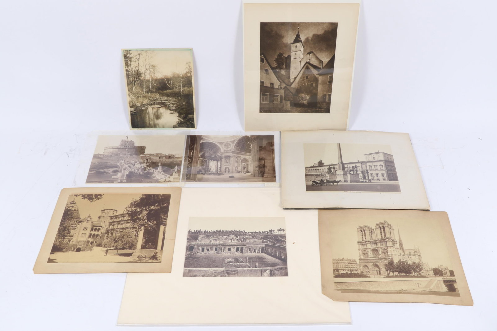 Collection of antique European architectural and landscape photographs: 16'H x 20'W (largest, mat): Collection of antique European architectural and landscape photographs: Interior forest landscape with creek. "When Nights Were Bold (Northern Bavaria, Early Morn.)" by Adolf Fassbender, featured as p