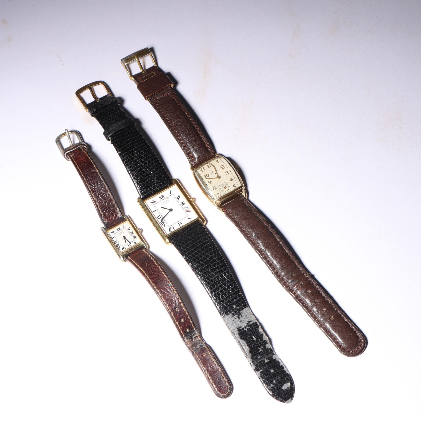 Three vintage women's wristwatches: Seiko, Lord Elgin 8 1/2'L x 1'W (watch with black strap): Three vintage women's wristwatches: Seiko, Lord Elgin Seiko watch with embossed leather strap, Seiko watch with black lizard grain strap made in Germany, Lord Elgin 10k gold-filled watch with leather