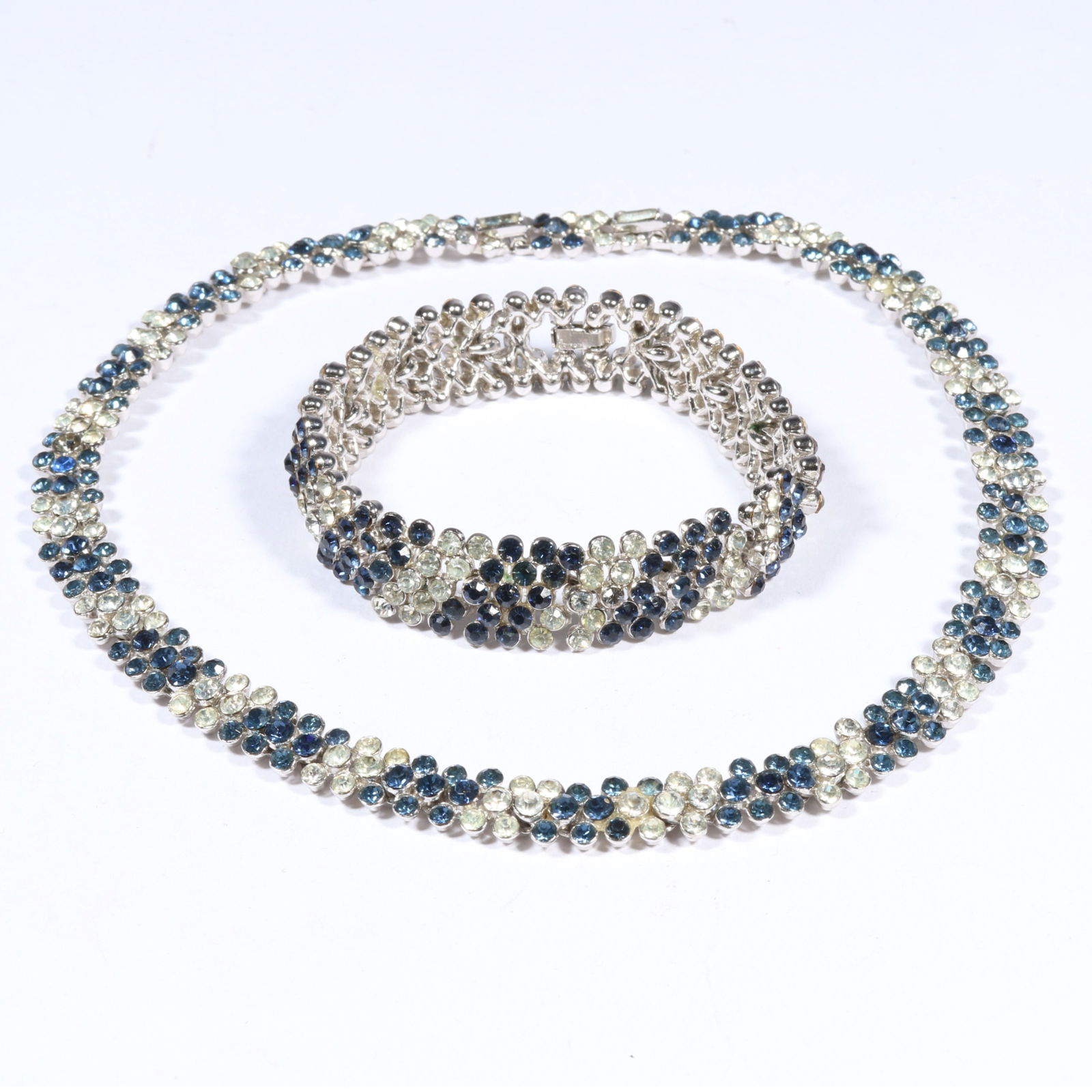 Trifari matching rhinestone crystal set with necklace and bracelet. 7 1/8'L x 1/2'W (bracelet): Trifari matching rhinestone crystal set with necklace and bracelet. With original paper tags. 7 1/8"L x 1/2"W (bracelet)