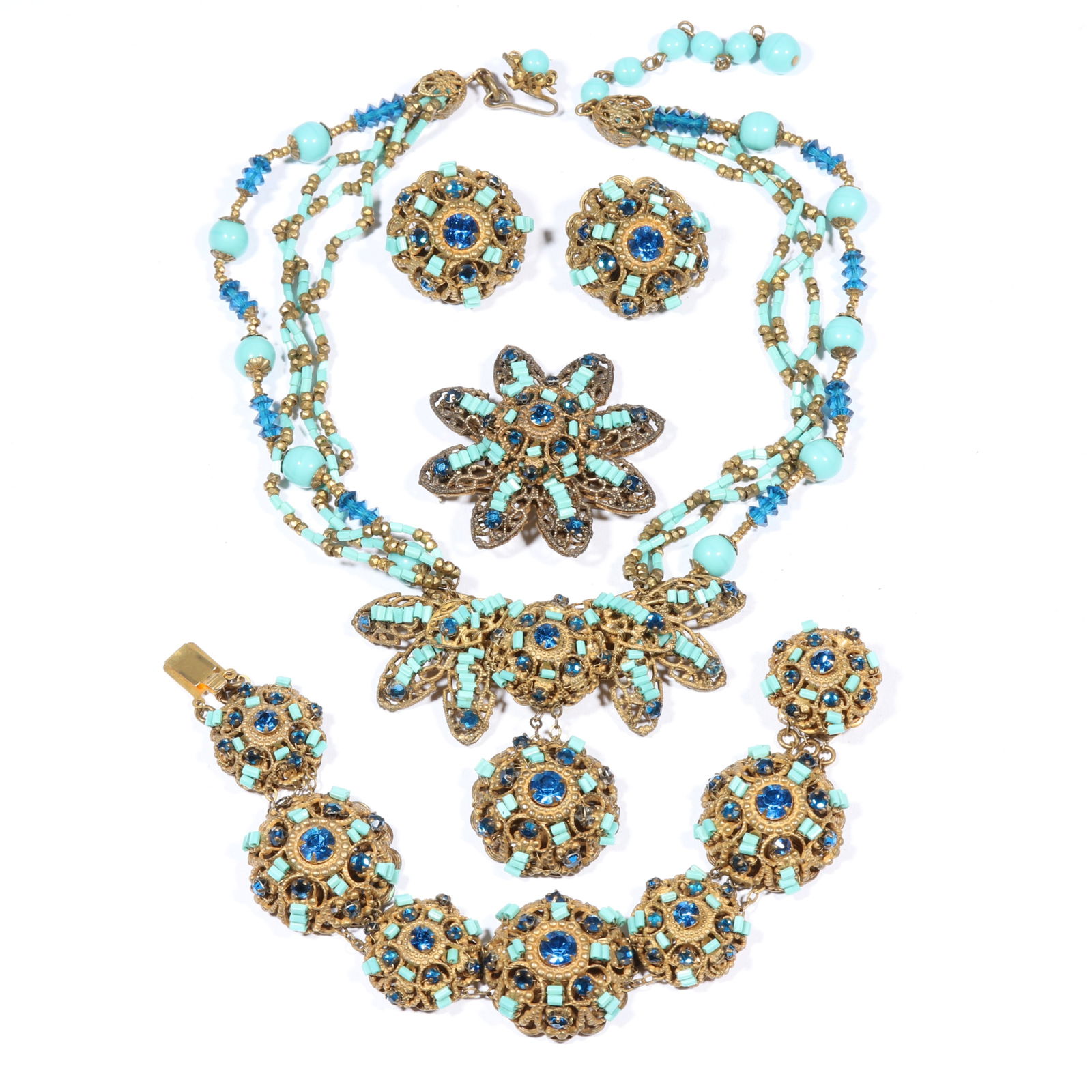Miriam Haskell parure: necklace, bracelet, brooch, and earrings decorated with turquoise glass seed: Miriam Haskell parure: necklace, bracelet, brooch, and earrings decorated with turquoise glass seed beads, dark blue rhinestone crystals, and gold colored beads. 7 1/4"L x 1"W (bracelet)Provenance: In