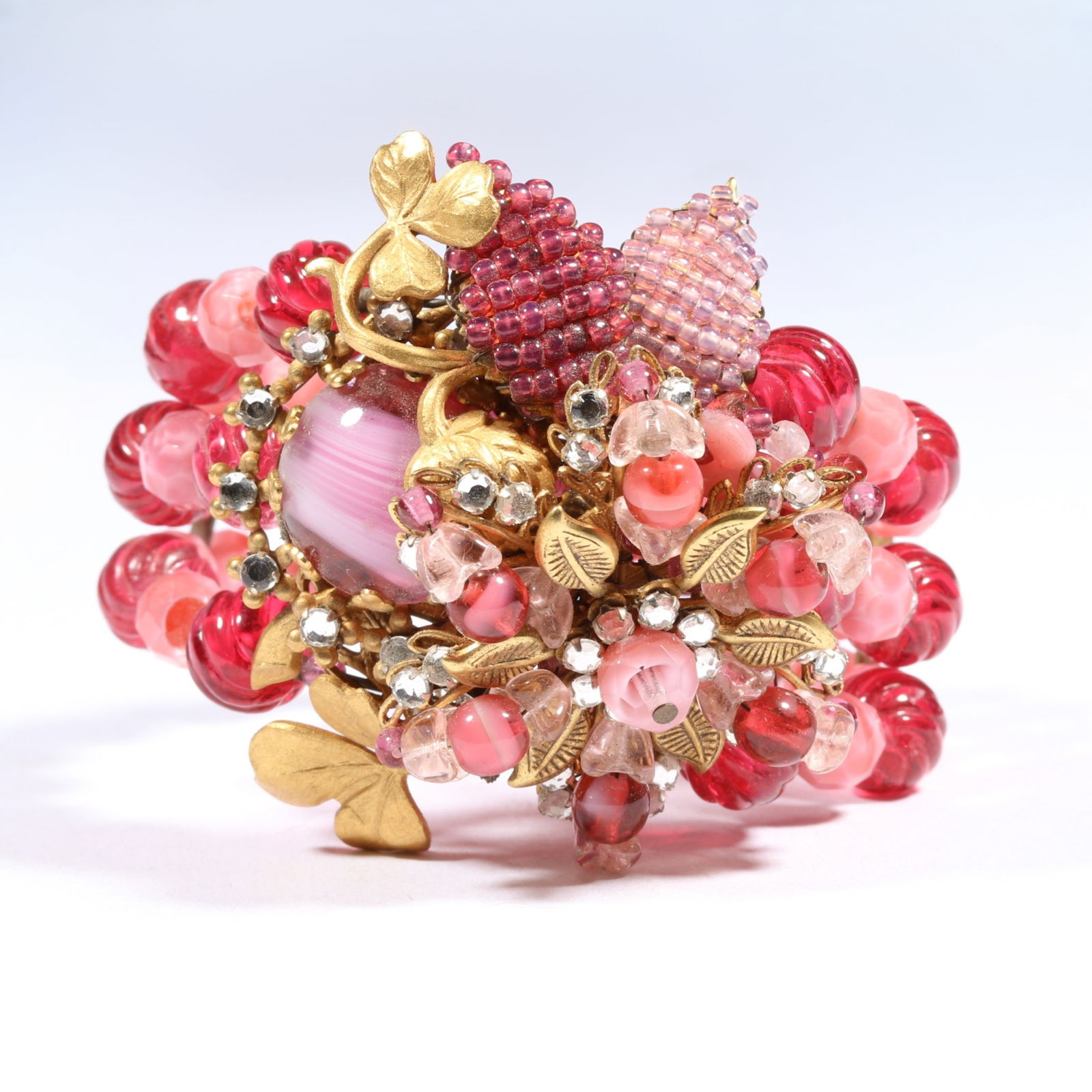 Miriam Haskell ornate pink art glass bracelet with intricate beadwork, gilt clover accents. 2 1/4'H: Miriam Haskell ornate pink art glass bracelet with intricate beadwork, gilt clover accents. 2 1/4"H x 2"Inner Diameter (adjustable)Provenance: Inga Levin at Queensantiques LL collection