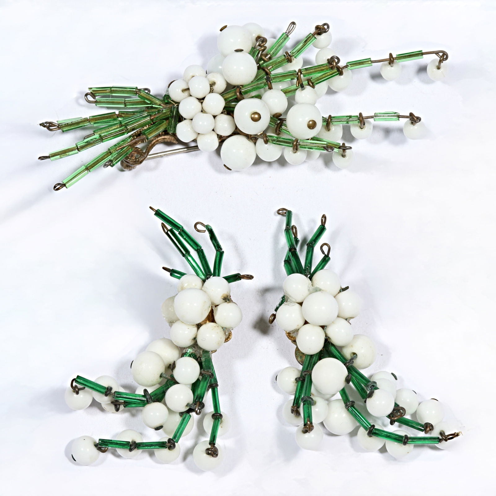 Miriam Haskell Lily of the Valley matching set of green barrel bead brooch with milk glass drops and: Miriam Haskell Lily of the Valley matching set of green barrel bead brooch with milk glass drops and matching unsigned earrings. Earrings have been repaired? with glue 3 5/8"H x 1 5/8"W (brooch)Proven