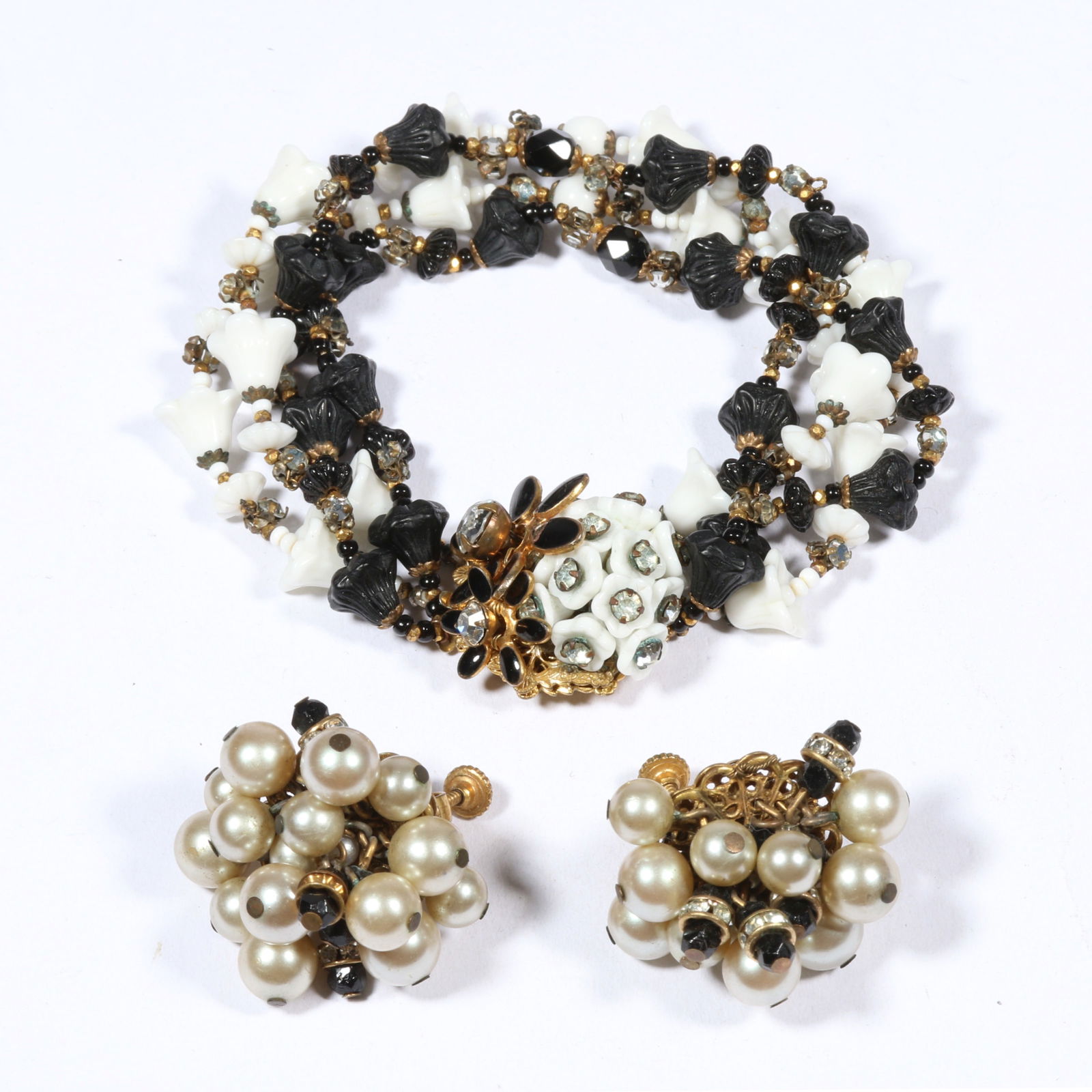 Miriam Haskell jewelry group including black and white floral glass beaded bracelet with: Miriam Haskell jewelry group including black and white floral glass beaded bracelet with complementary faux pearl and black glass dangle earrings. 7 1/2"L x 1 3/8"W (bracelet)