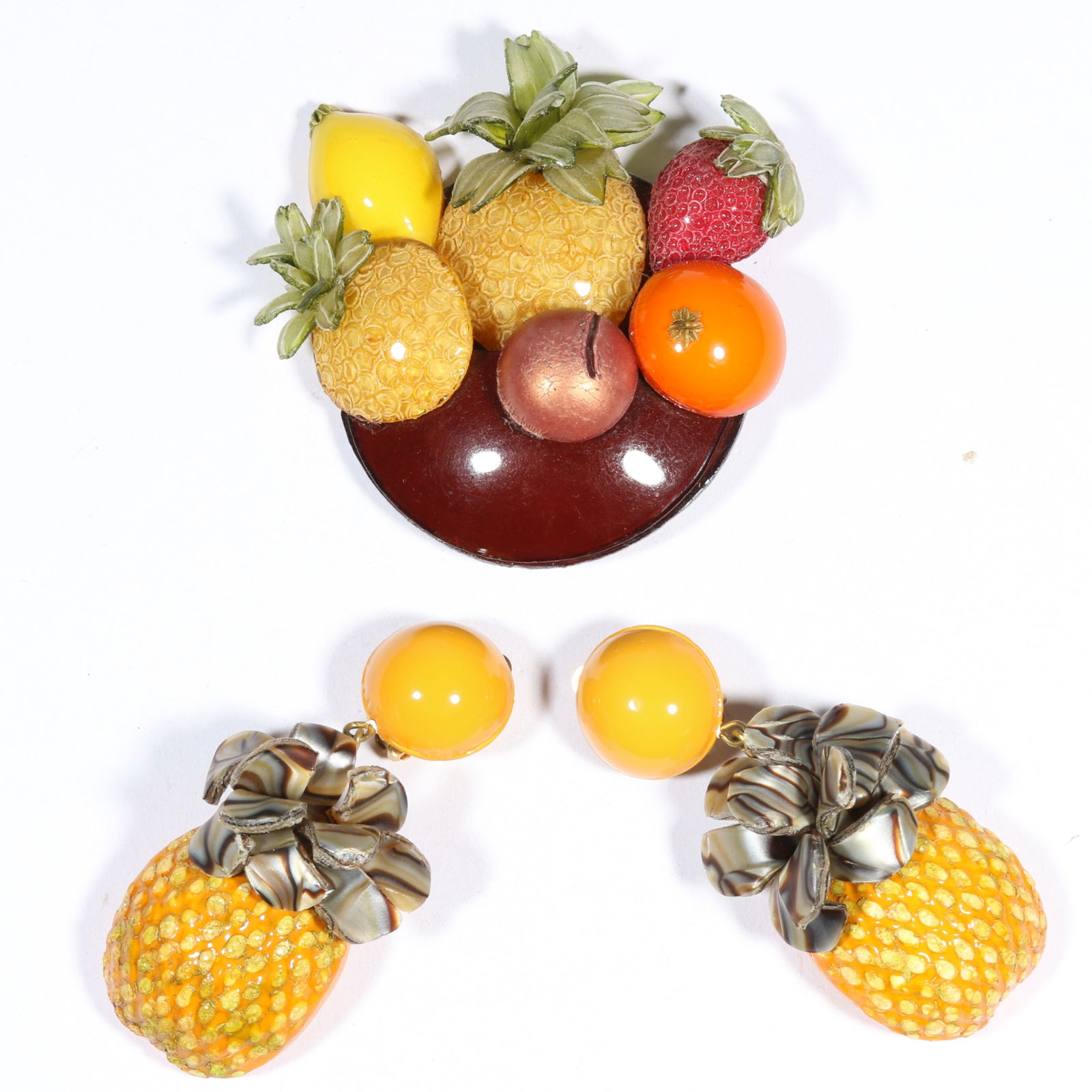 Cilea Paris puffed resin fruit bowl brooch and accompanying pineapple earrings. 2 7/8'H x 2 7/8'W: Cilea Paris puffed resin fruit bowl brooch and accompanying pineapple earrings. 2 7/8"H x 2 7/8"W (brooch)Provenance: Inga Levin at Queensantiques LL collection