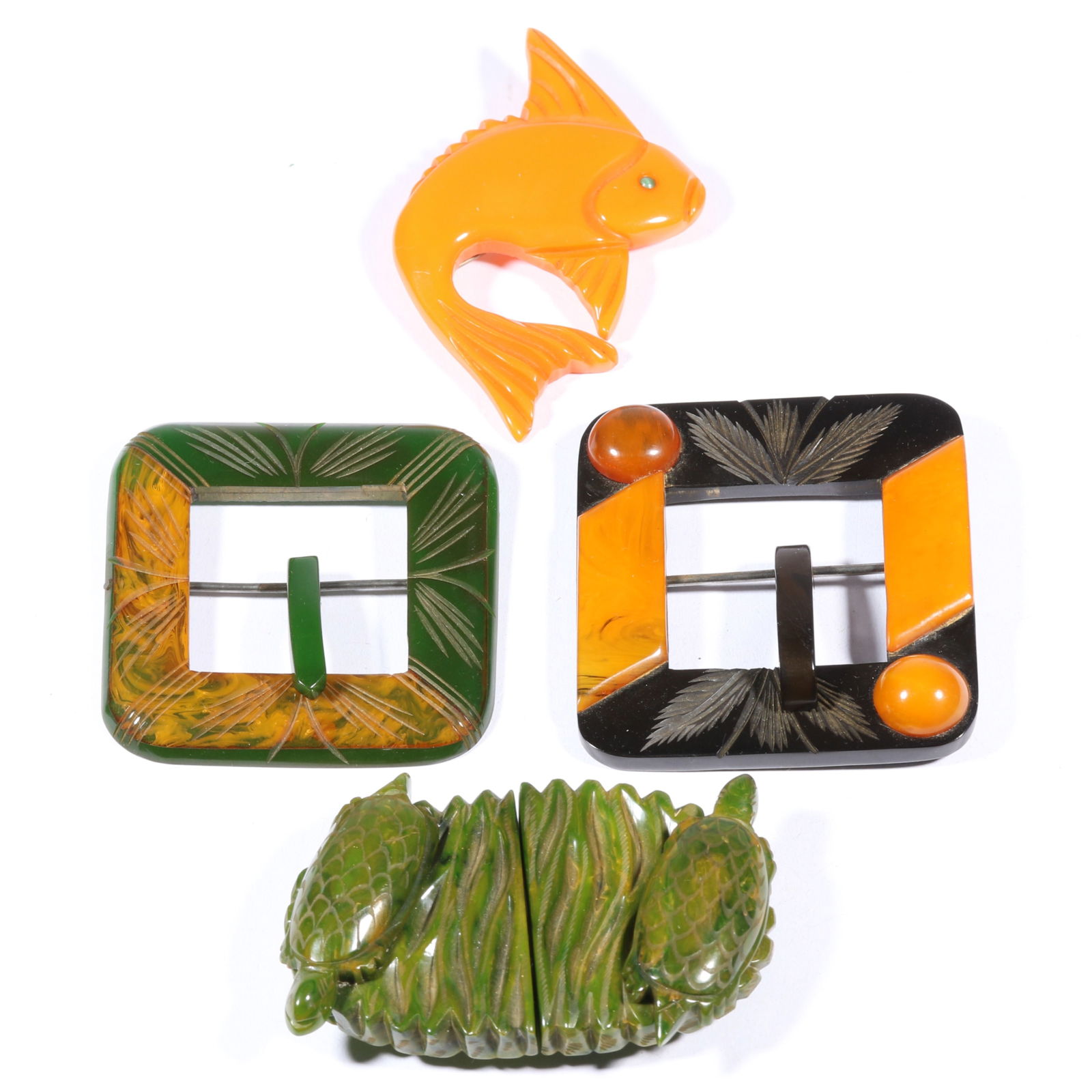 Vintage Bakelite 4pc. group including carved fish brooch, pair of two tone carved buckles, and (1 of 8)