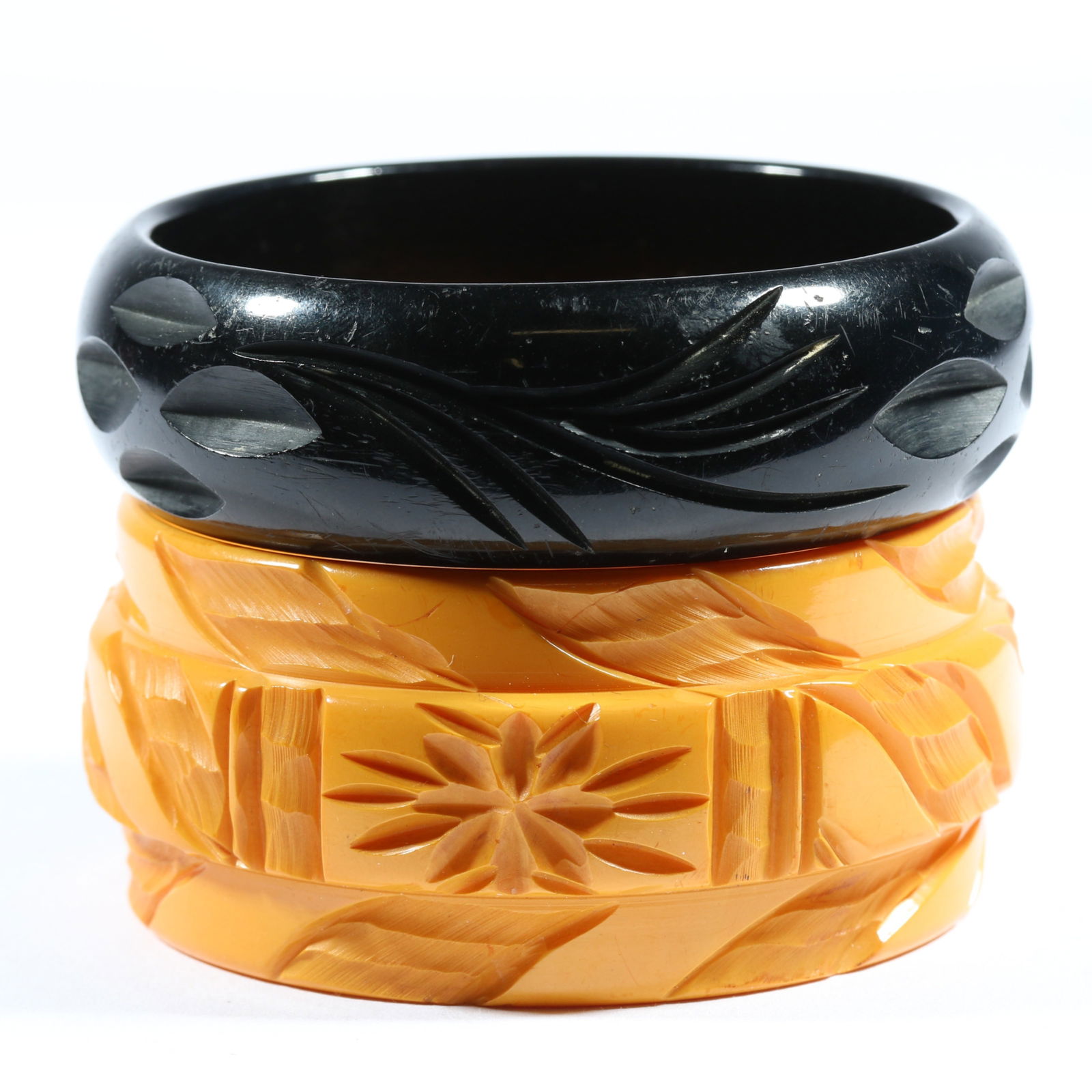 Vintage deeply carved pair of Bakelite bangle bracelets. 1 3/8'H x 2 1/2'Inner Diameter (largest) (1 of 5)